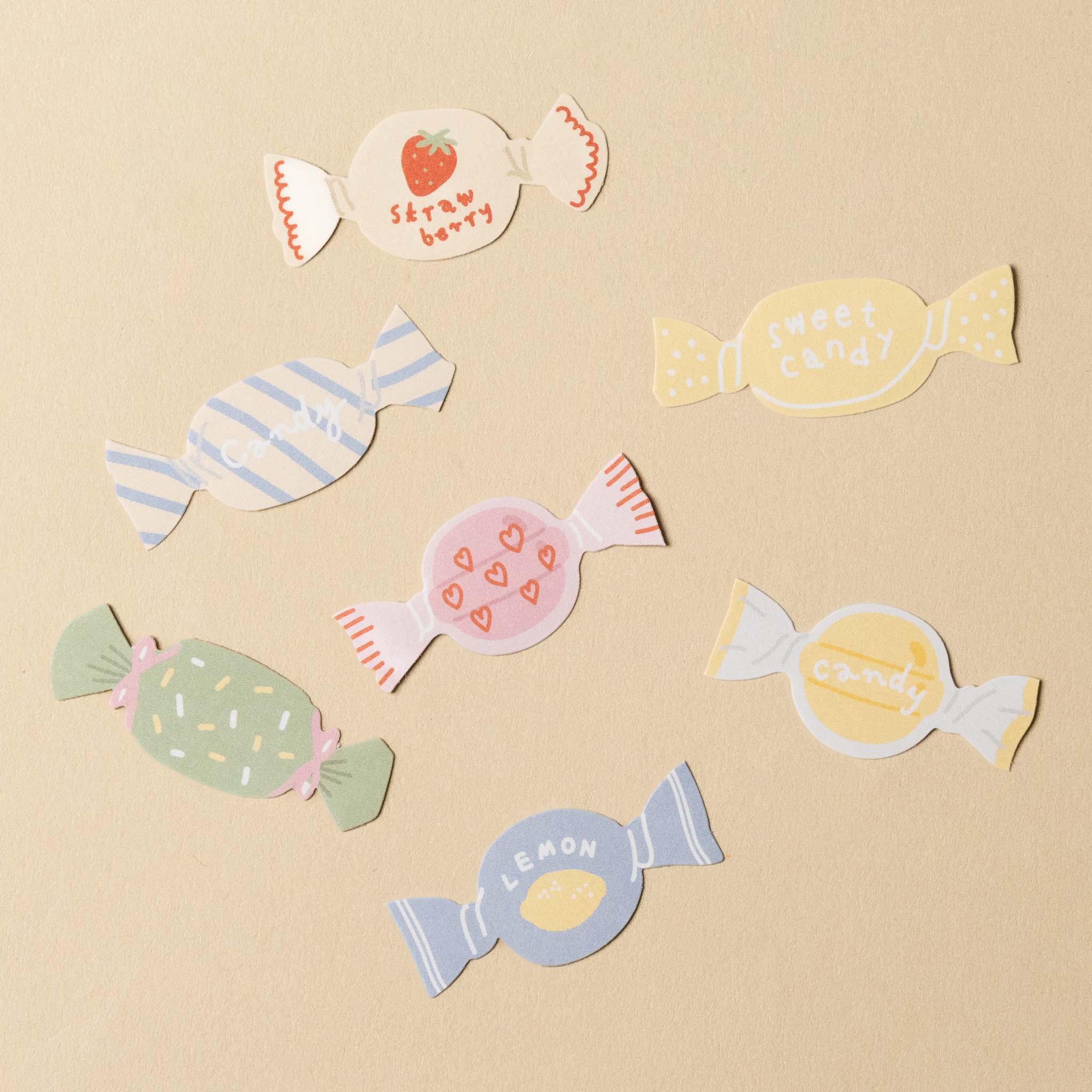 Colorful candy-shaped stickers on a beige background