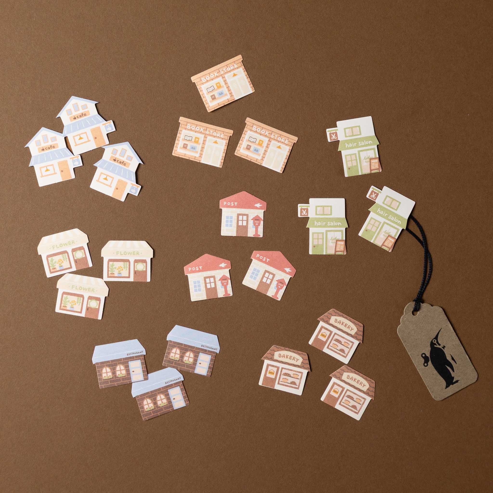 cereal-sticker-set-shoppes Small paper houses on a brown background with a tag 