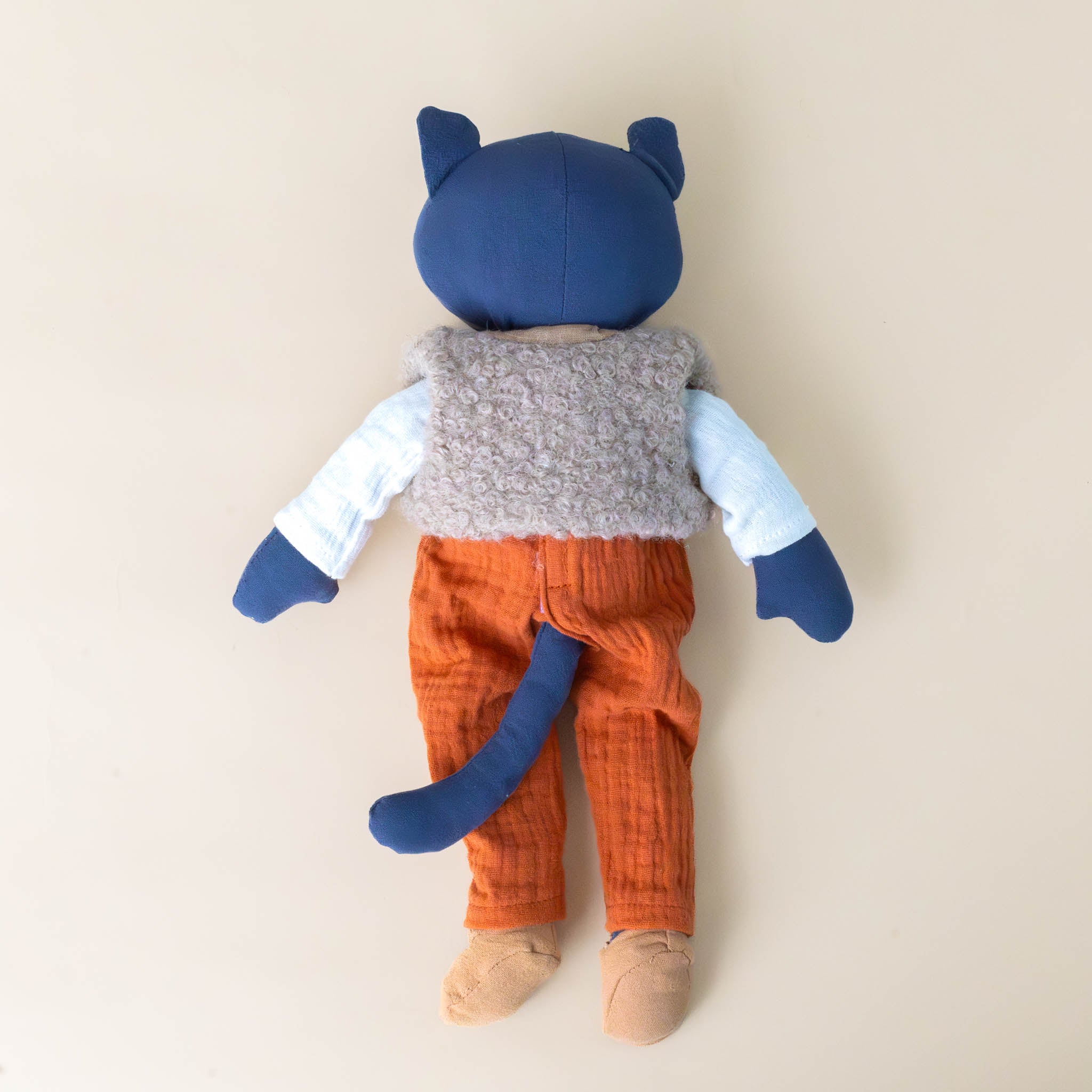 cesar-the-blue-cat-with-cream-shirt-tan-vest-brown-shoes-and-orange-overalls-back-side-with-tail