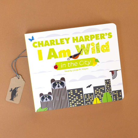 charley-harpers-i-am-wild-in-the-city-board-book-cover-with-skyscrapers-with-raccoon-heads-and-birds-flying