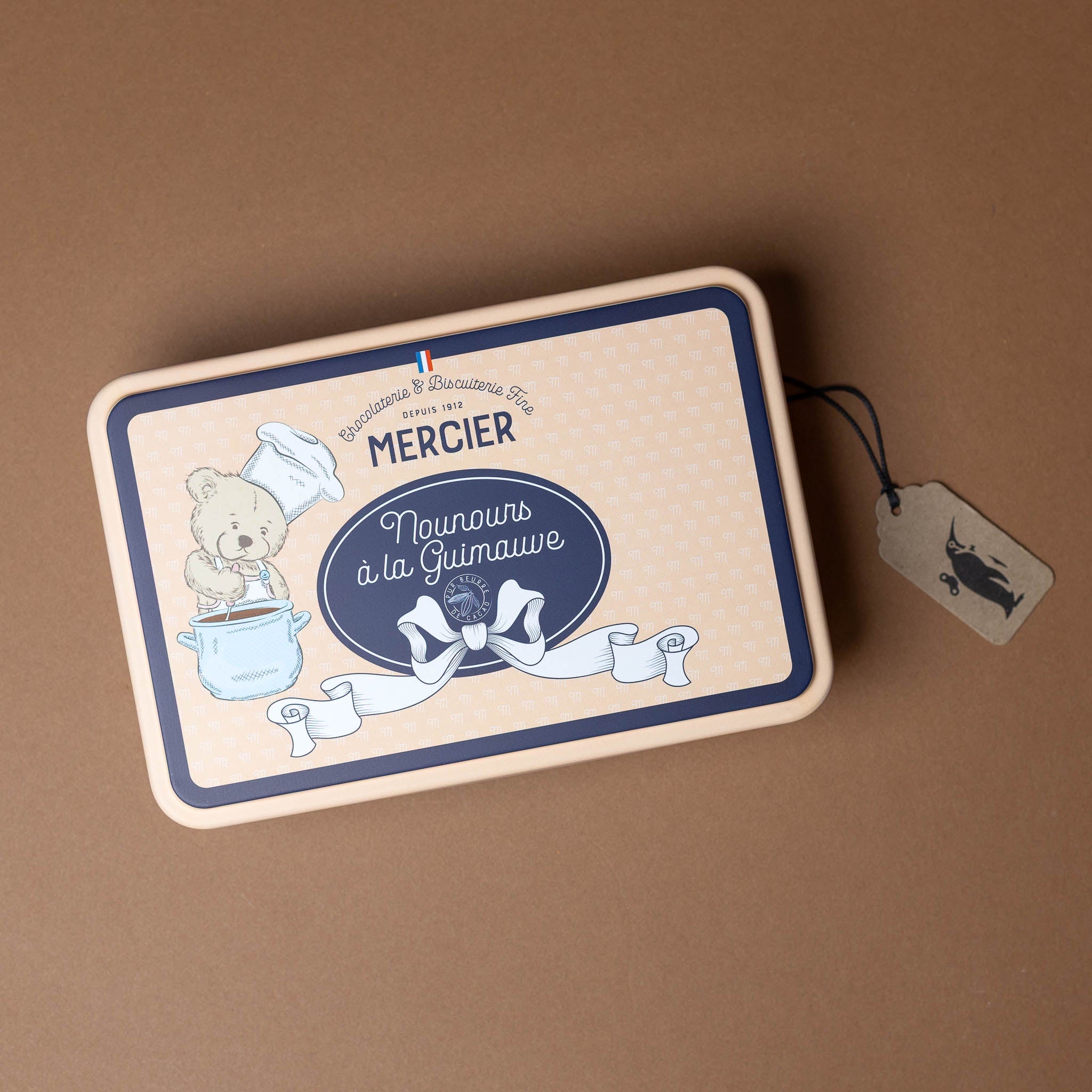 chocolate-covered-marshmallows-in-gift-tin Rectangular tin box with teddy bear illustration and text on a brown background