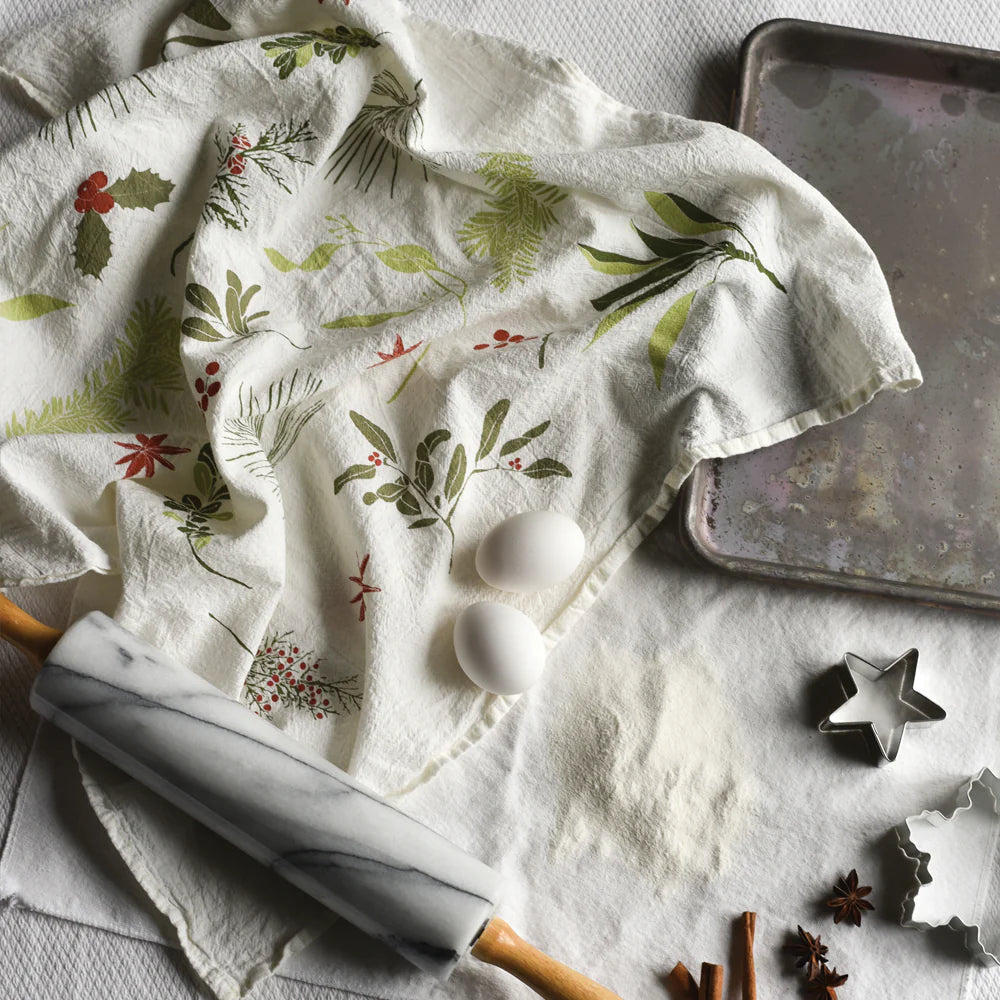 boughs_and_berries_towel_Floral-patterned towel with eggs, rolling pin, and baking tray on a textured surface