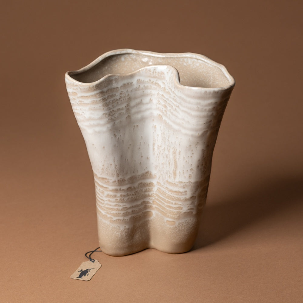 claribel-vase-tall Beige ceramic vase with wavy texture on a brown background