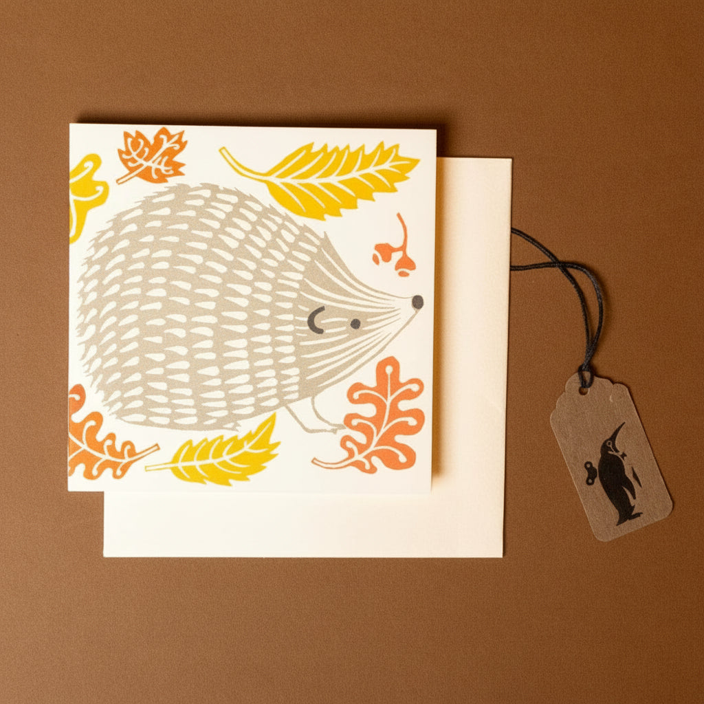 concertina-greeting-card--prickle-of-hedgehogs illustration and leaves on a brown background
