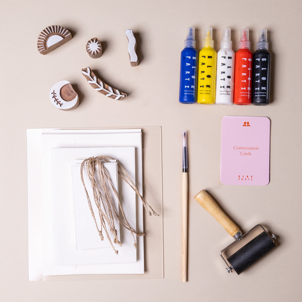 create-your-own-block-print-stationary-kit-cosmic Collection of printing tools and materials on a beige background