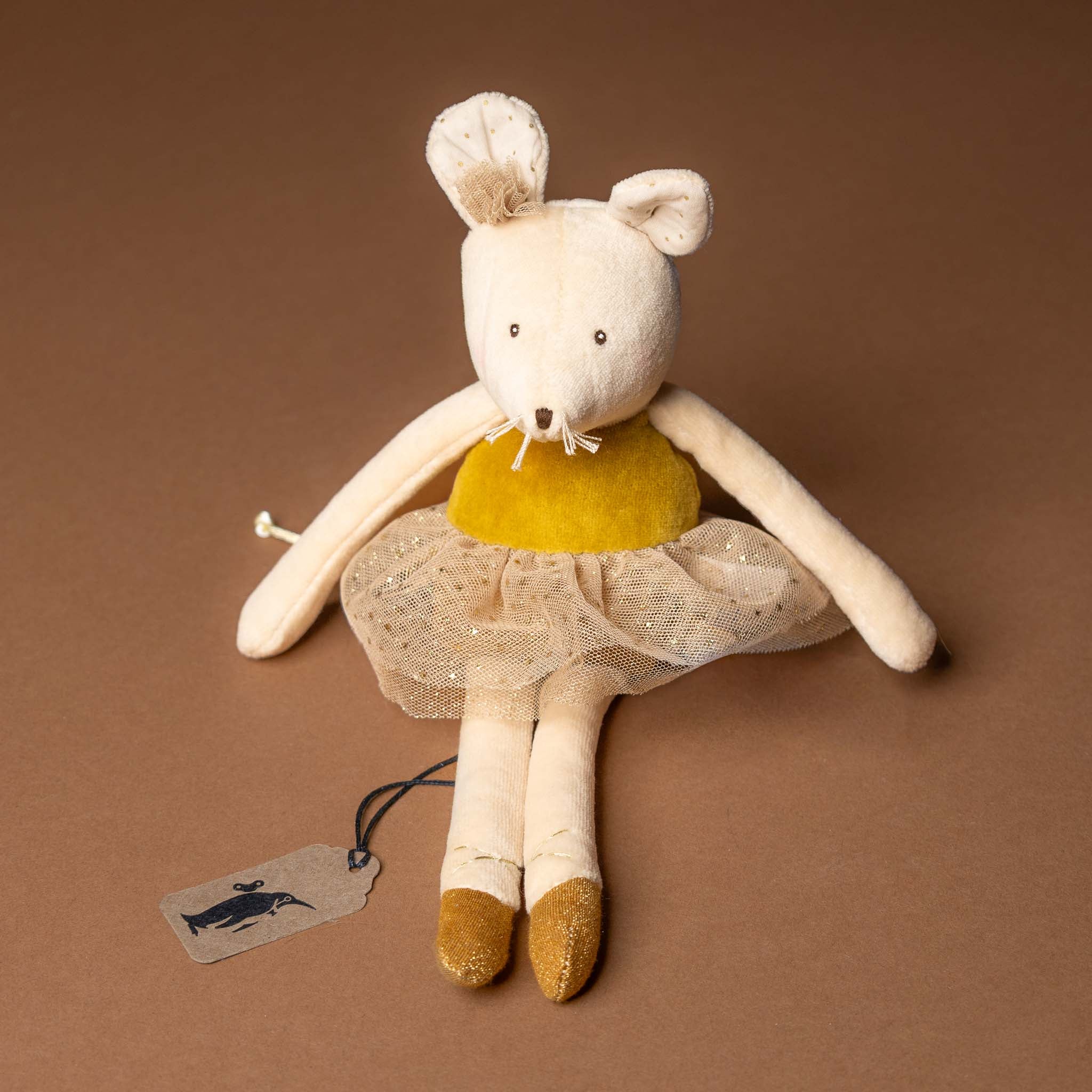 dance-mouse-golden-belle Stuffed mouse toy with a yellow top and beige skirt on a brown background