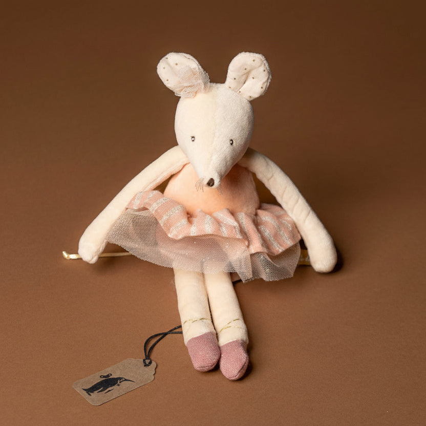 dance-mouse-rose Stuffed mouse toy in a pink dress with a tag on a brown background