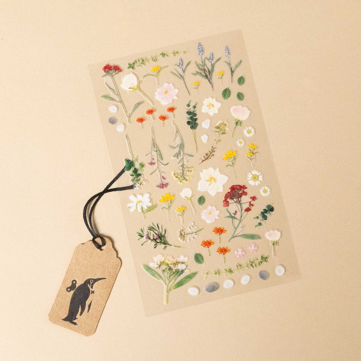 Sheet of floral stickers with a tag on a beige background
