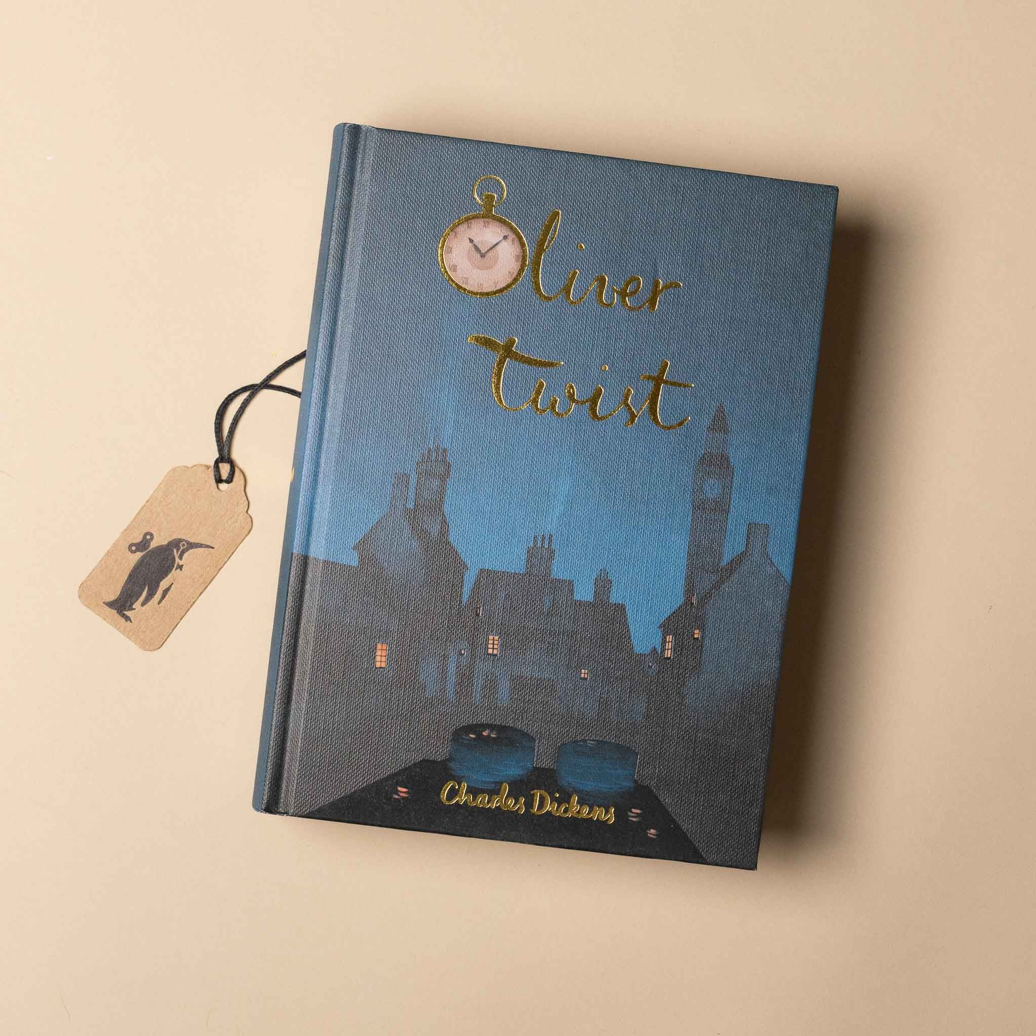 Book titled 'Oliver Twist' by Charles Dickens with a silhouette design on a beige background