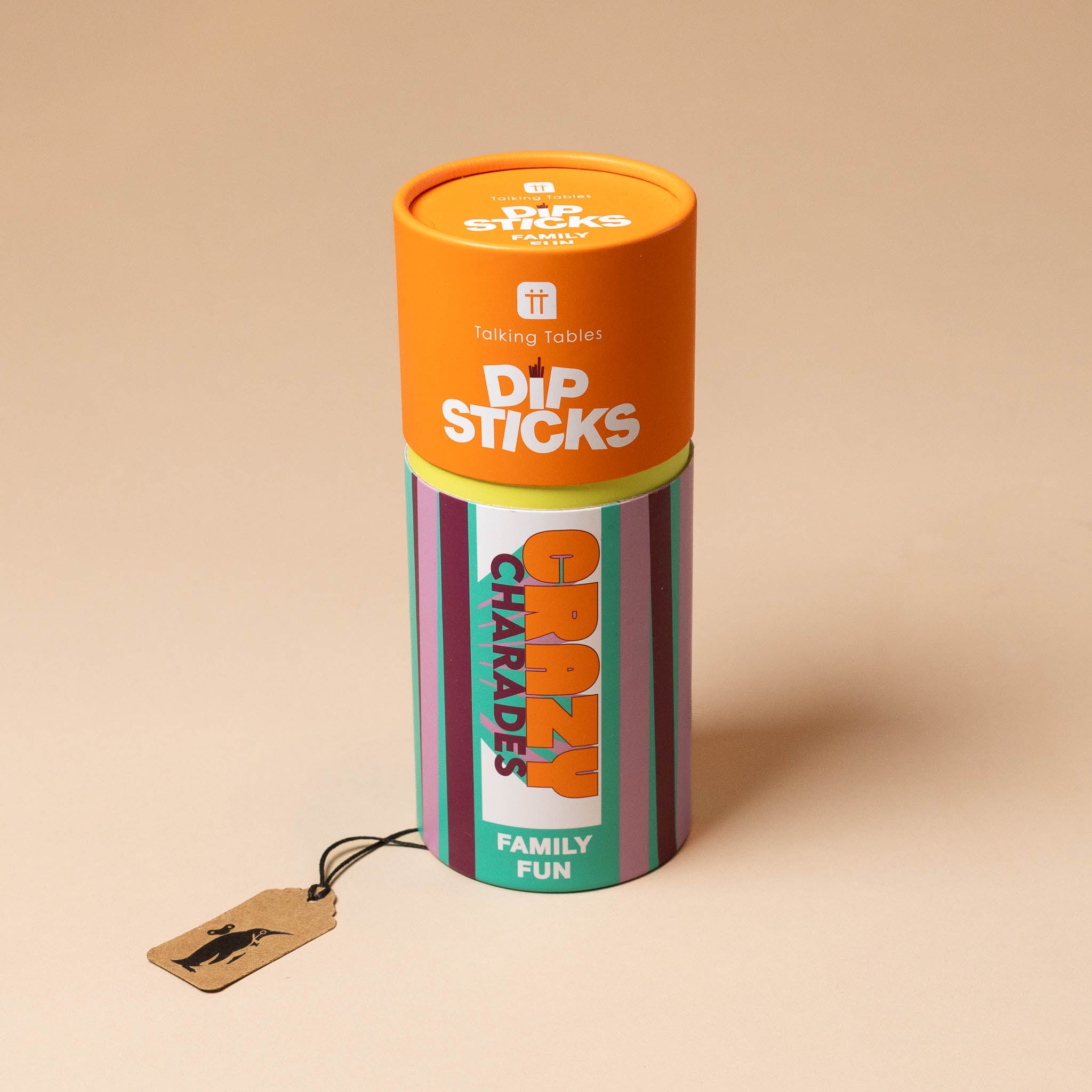 Tube packaging for 'Dip Sticks' with a tag labeled 'Charades Family Fun' on a beige background