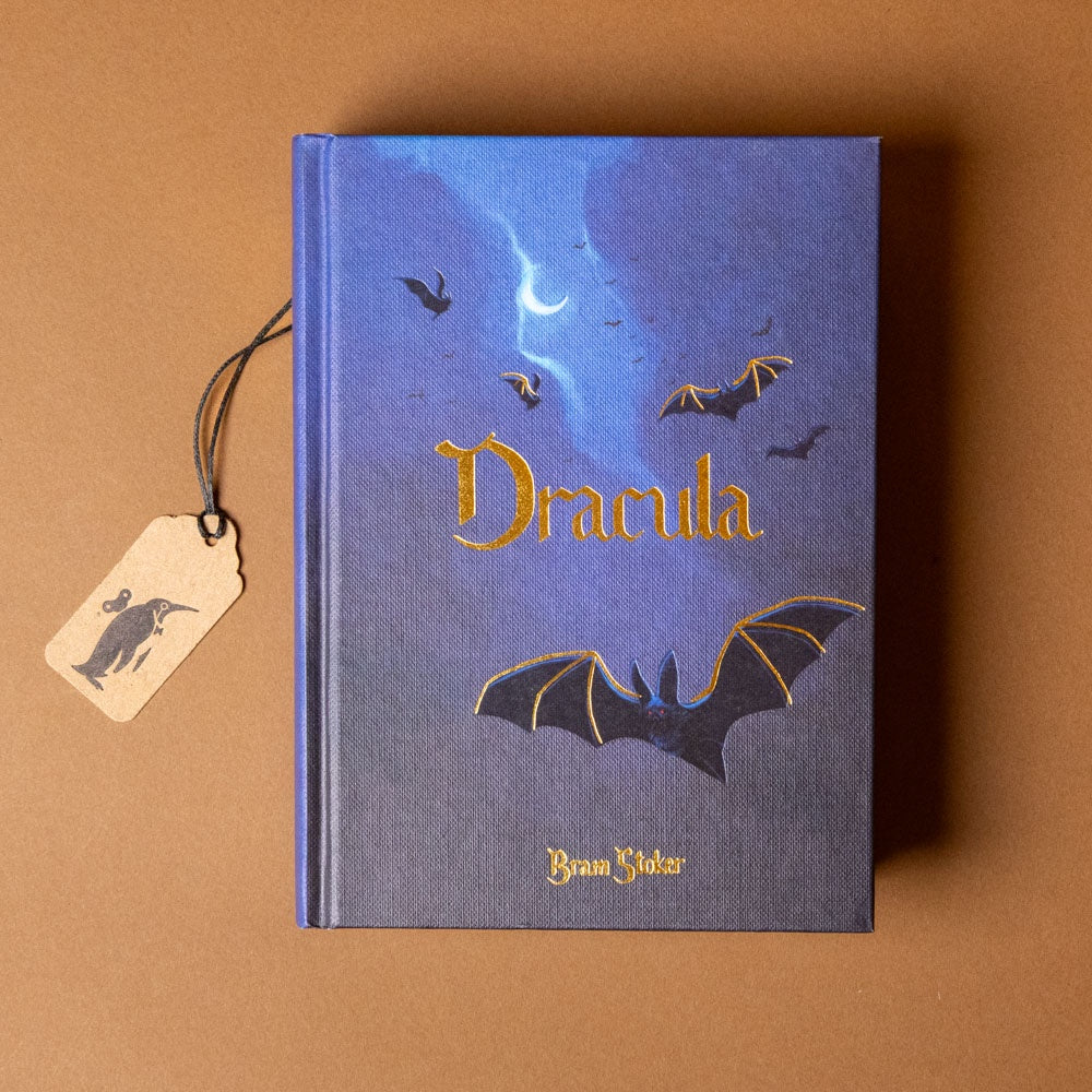 Book titled 'Dracula' with bat illustrations on a brown background