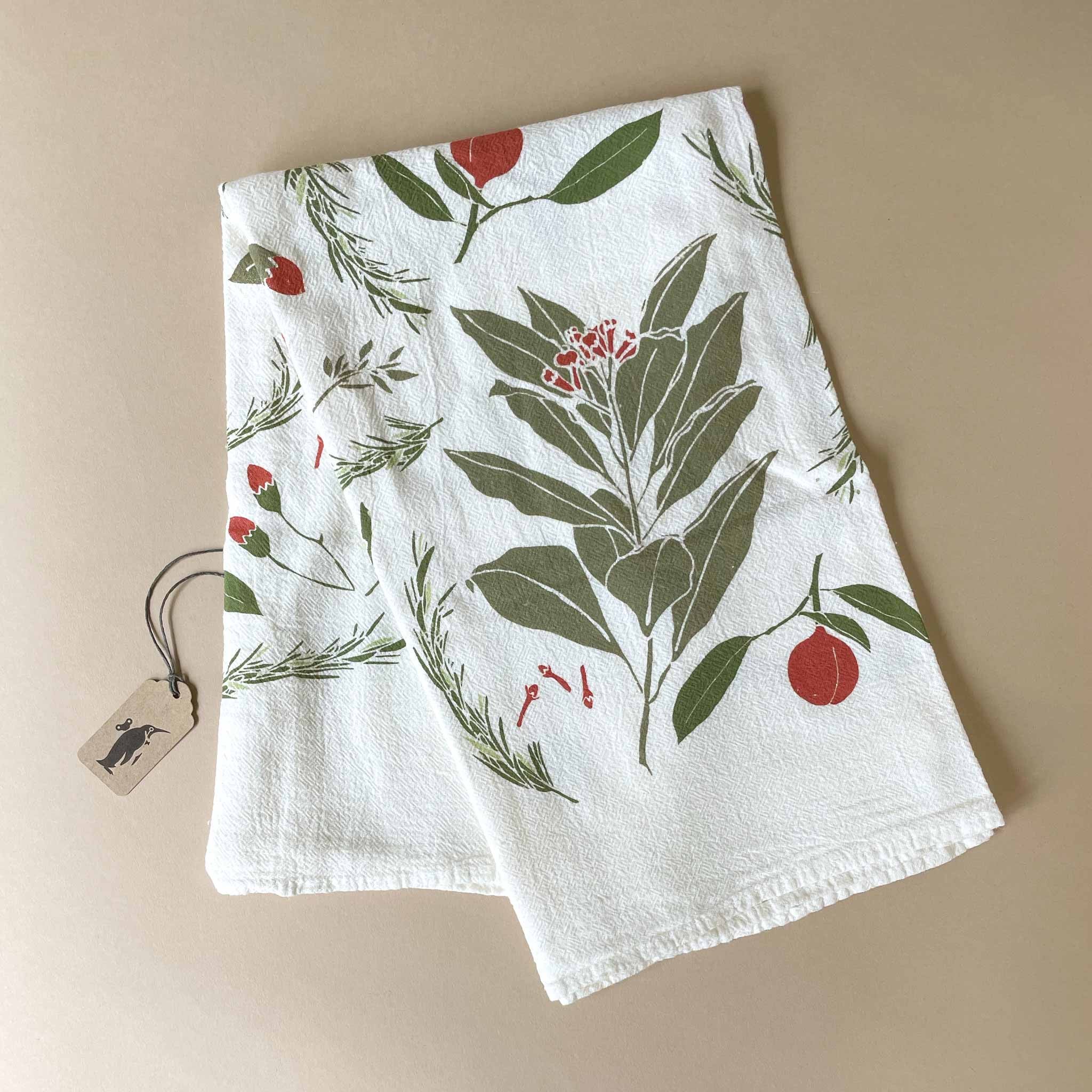  Festive Flavors kitchen towel  White towel with green leaf and red berry pattern on a beige background