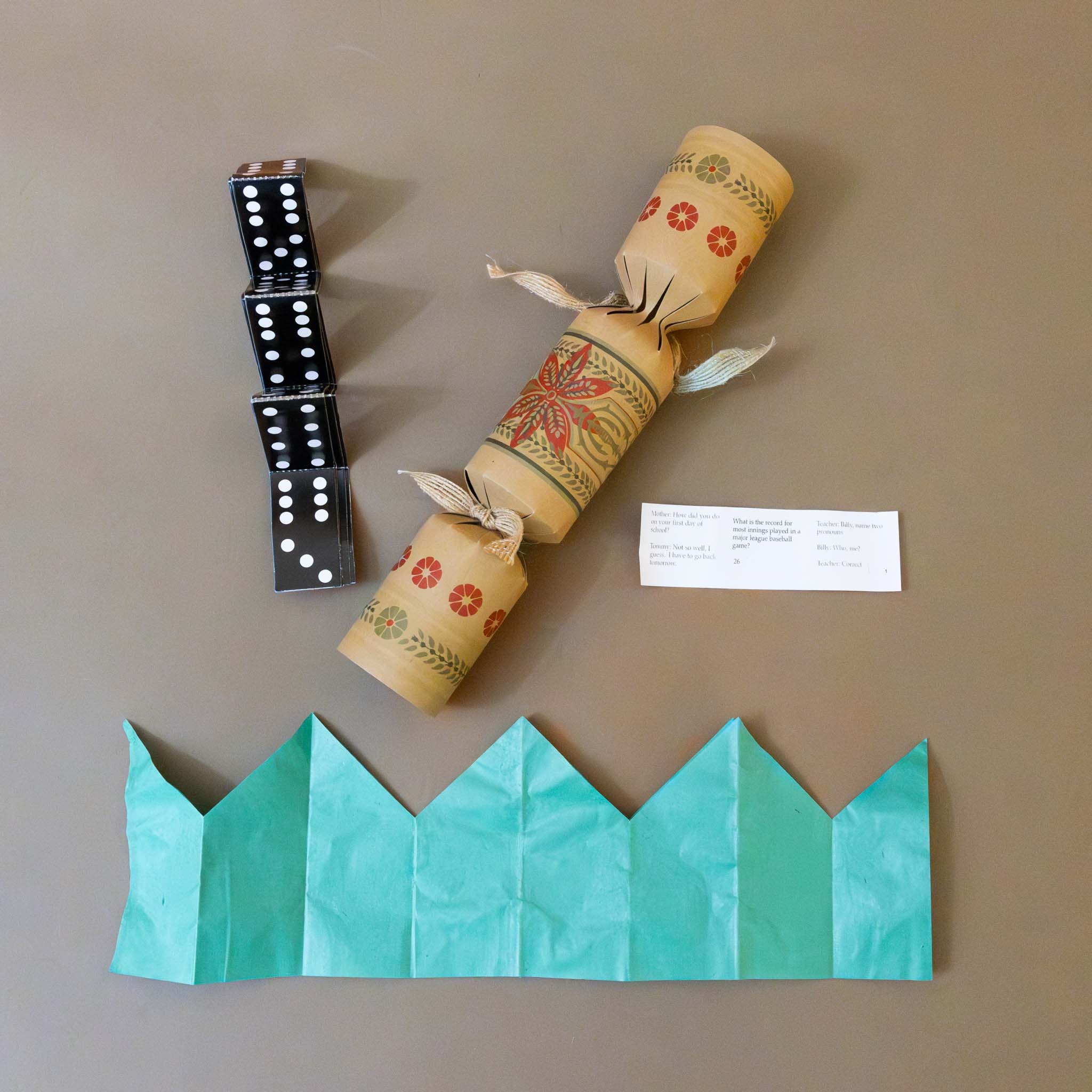 gift-inside-dominos-paper-crown-and-riddle 