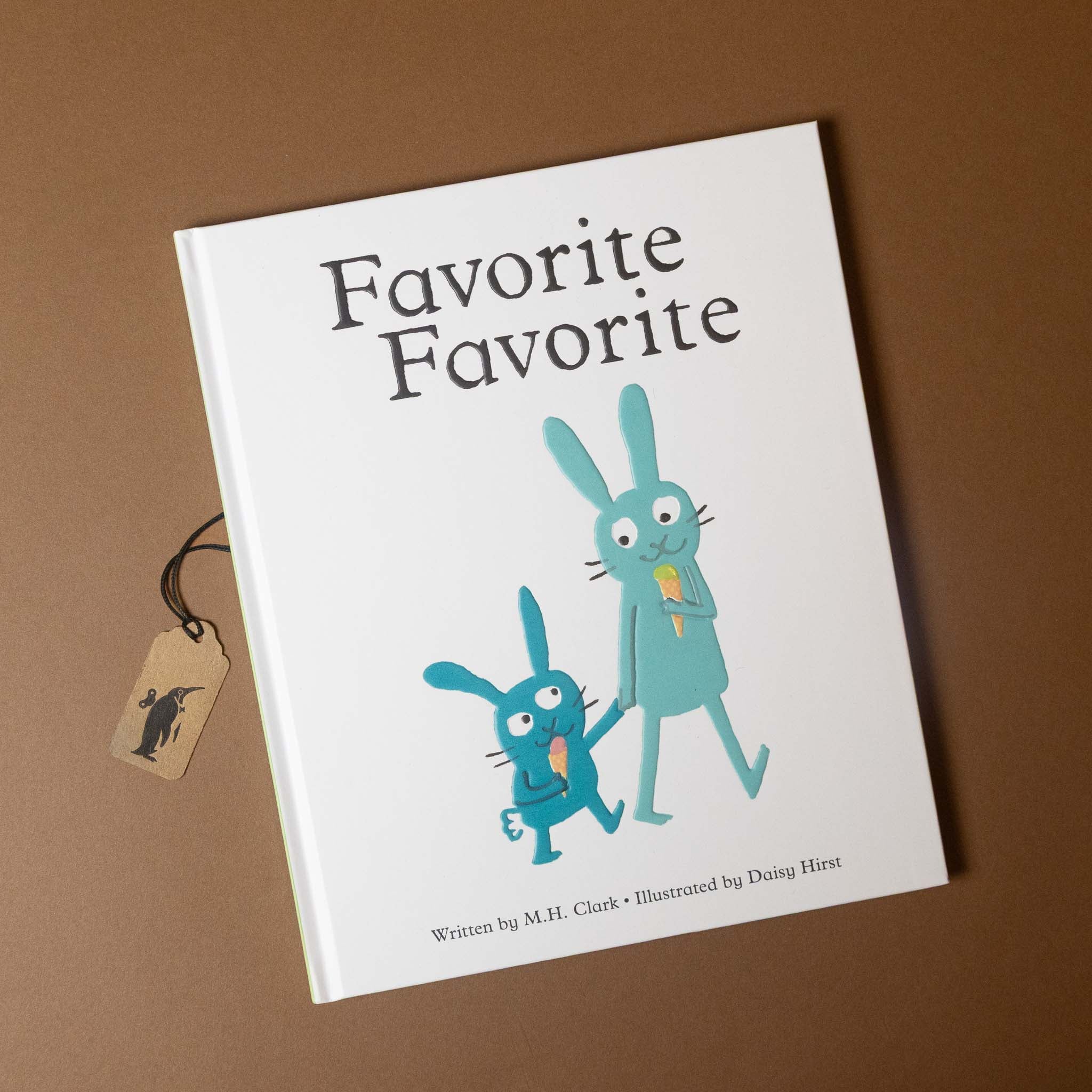 Book titled 'Favorite Favorite' with blue rabbit illustrations on a brown background