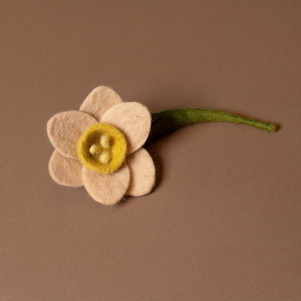 Felted flower on a brown background
