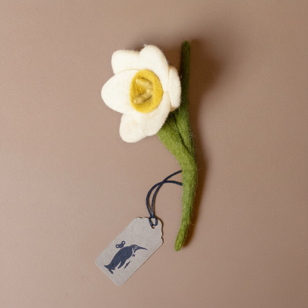 felt-daffodil-stem--white---short-flower with a yellow center on a brown background