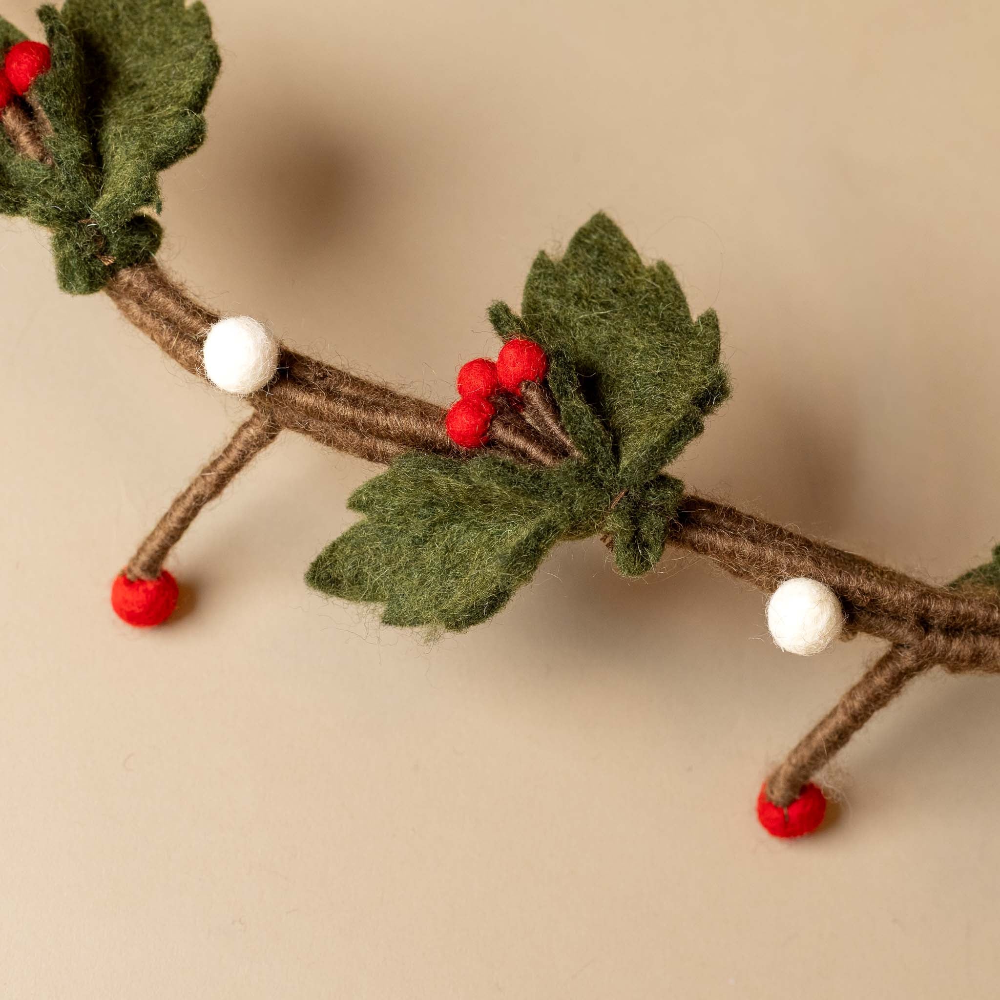 felt-holly-wreath-hanging-red-white-berries