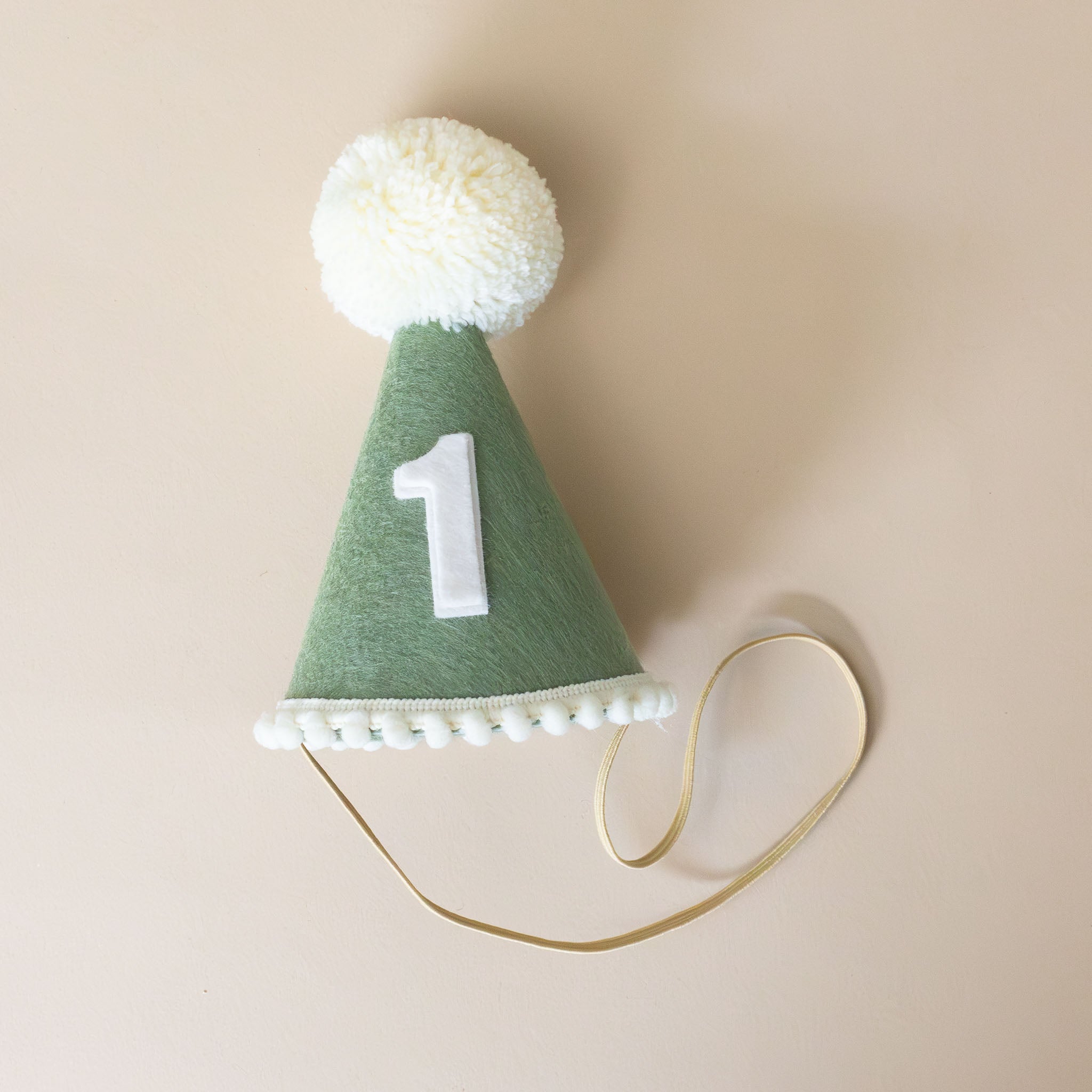 felt-white-pom-party-hat-olive-hat-with-number-one-on-front-with-strap