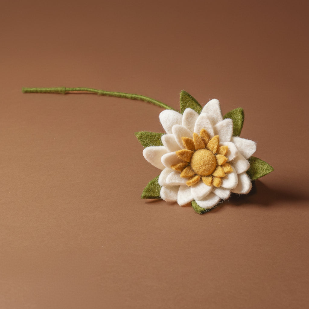 felt-water-lily-stem-white Felt flower with white petals and yellow center on a brown background