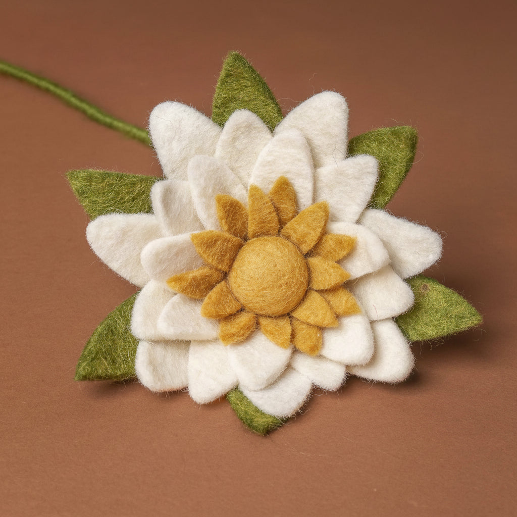 felt-water-lily-stem-white Felt flower with white petals and a yellow center on a brown background