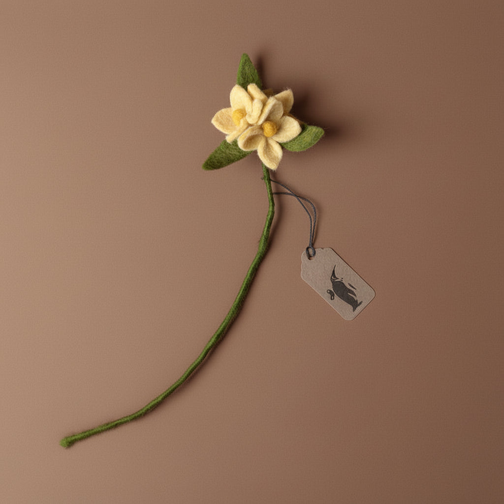 Felted butter yellow flower with green stem on a brown background