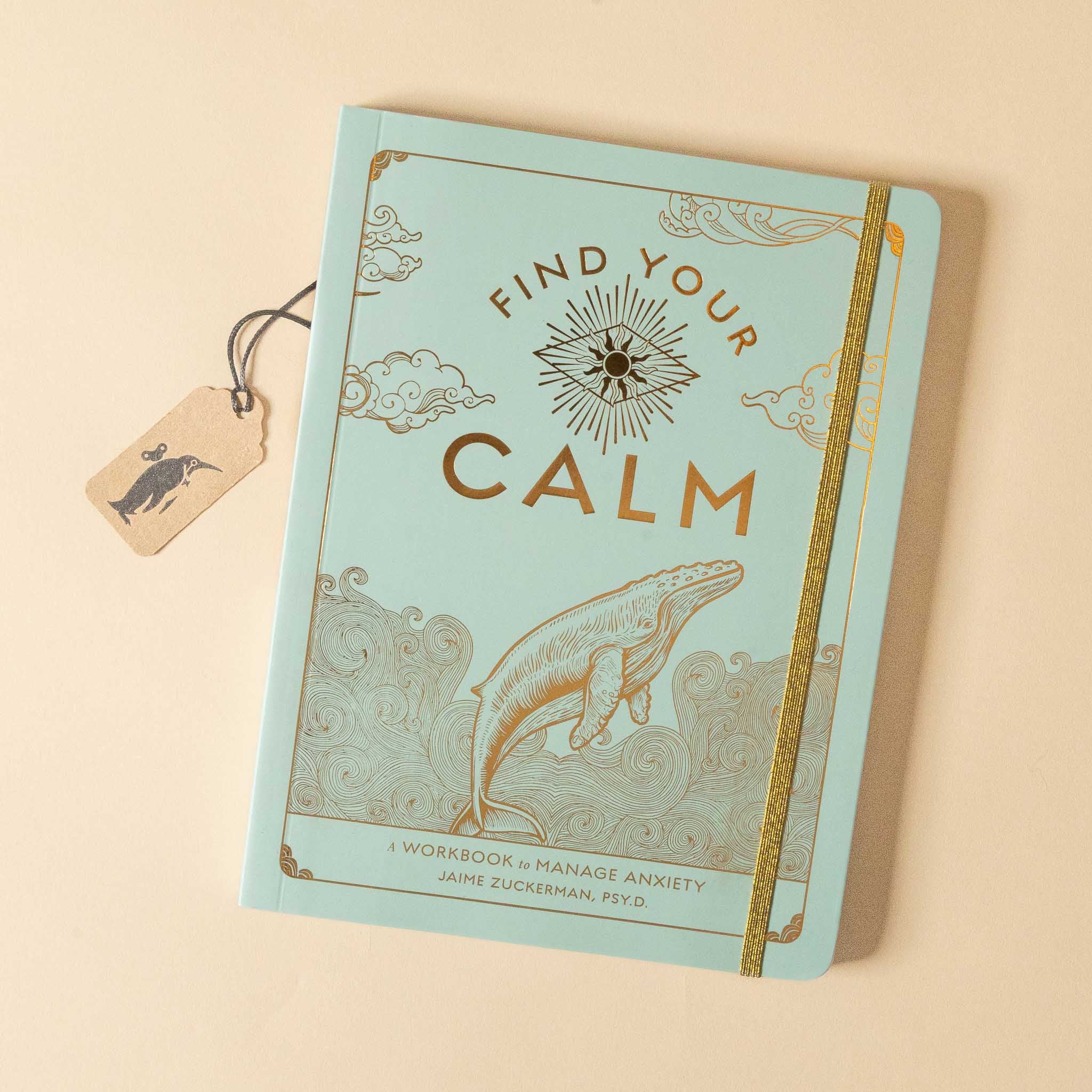 Book titled 'Find Your Calm' with a whale illustration on a beige background