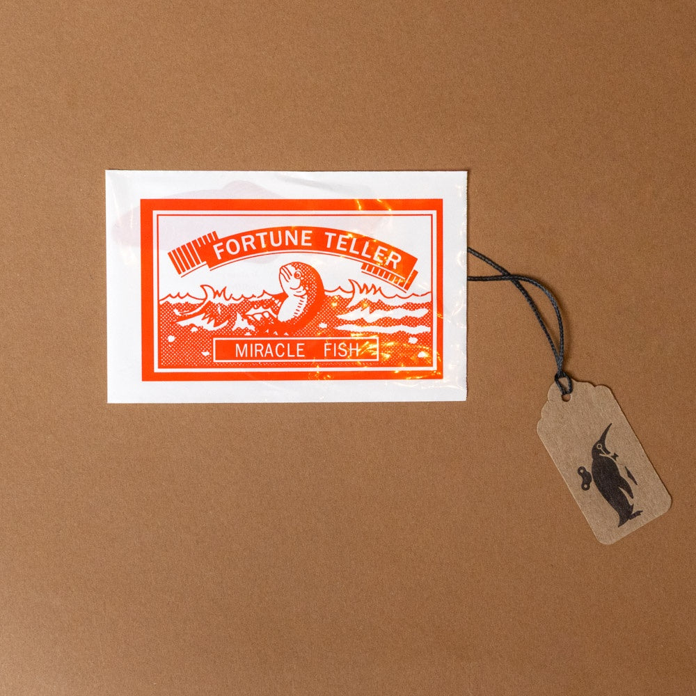Fortune Teller Miracle Fish packaging on a brown background