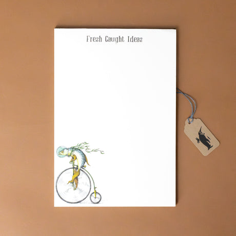 fresh-caught-ideas-notepad-with-a-fish-wearing-a-fish-bowl-as-he-rides-a-bike