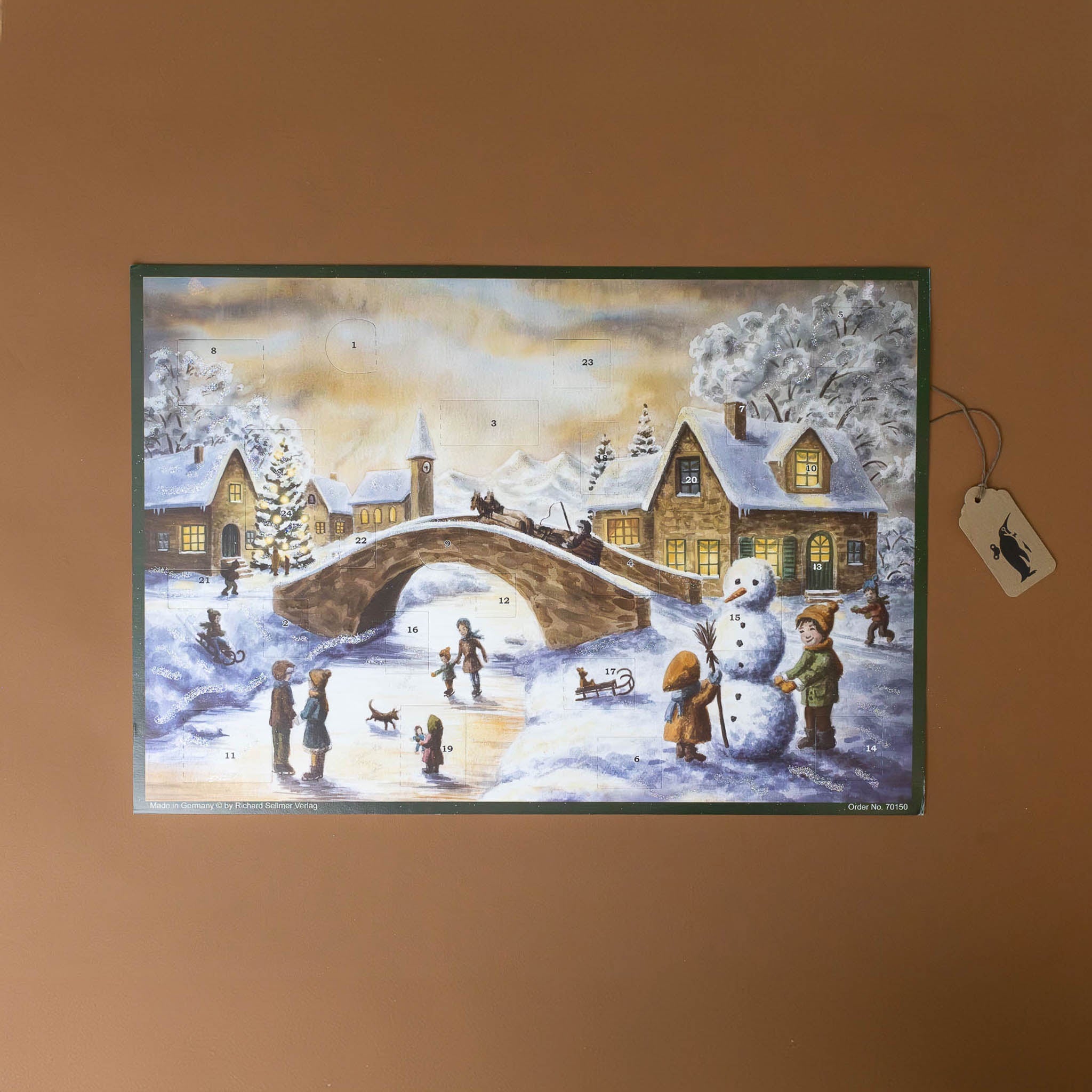 german-advent-calendar-river-crossing-with-children-building-a-snowman-people-walking-on-a-frozen-river-and-a-carriage-riding-over-a-bridge