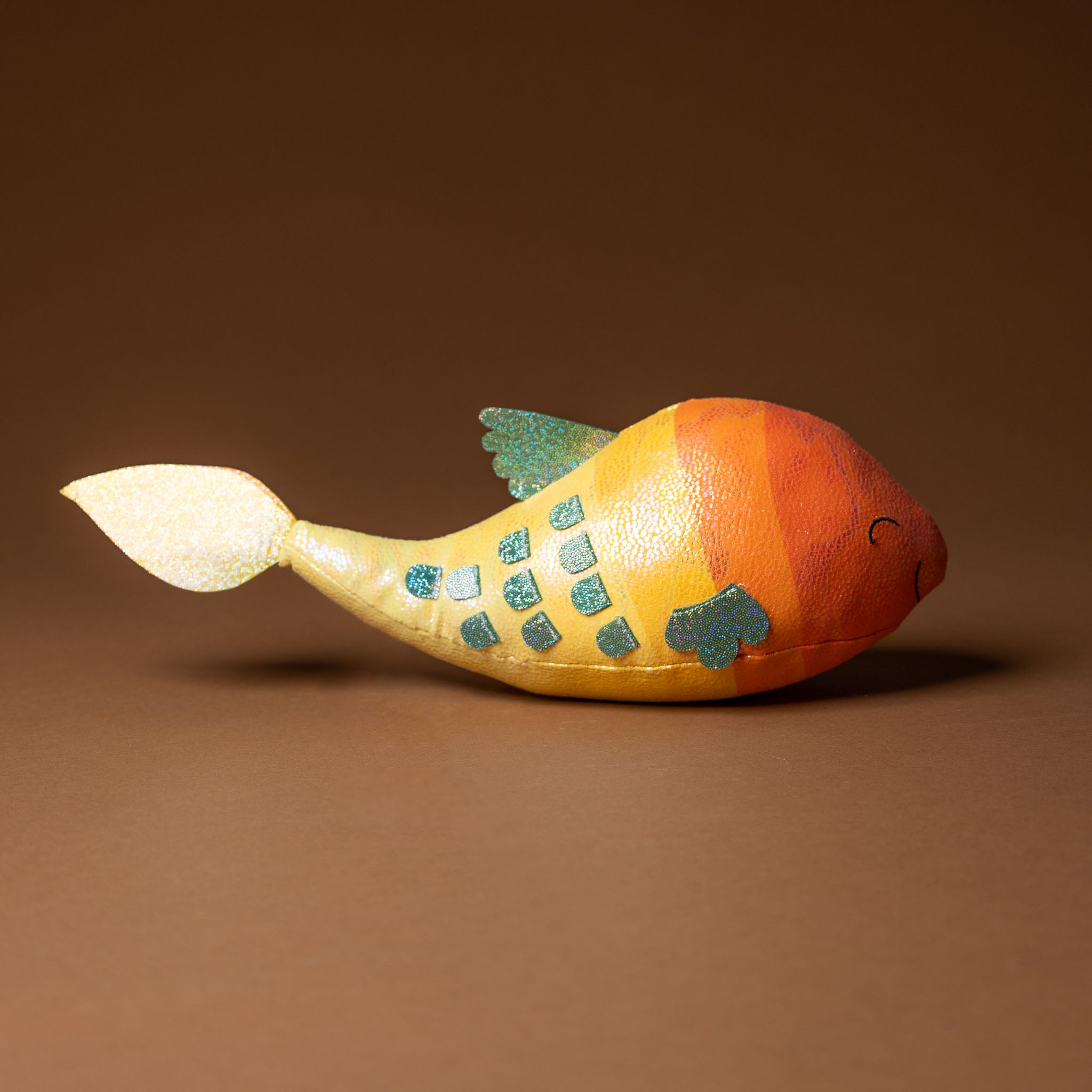 gil-the-guppie-fish Colorful fish-stuffed-animal on a brown background