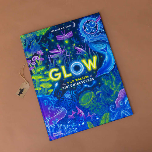 glow-the-wild-wonders-of-bioluminescence-cover-with-neon-green-blue-and-purple-creatures-above-and-below-the-sea