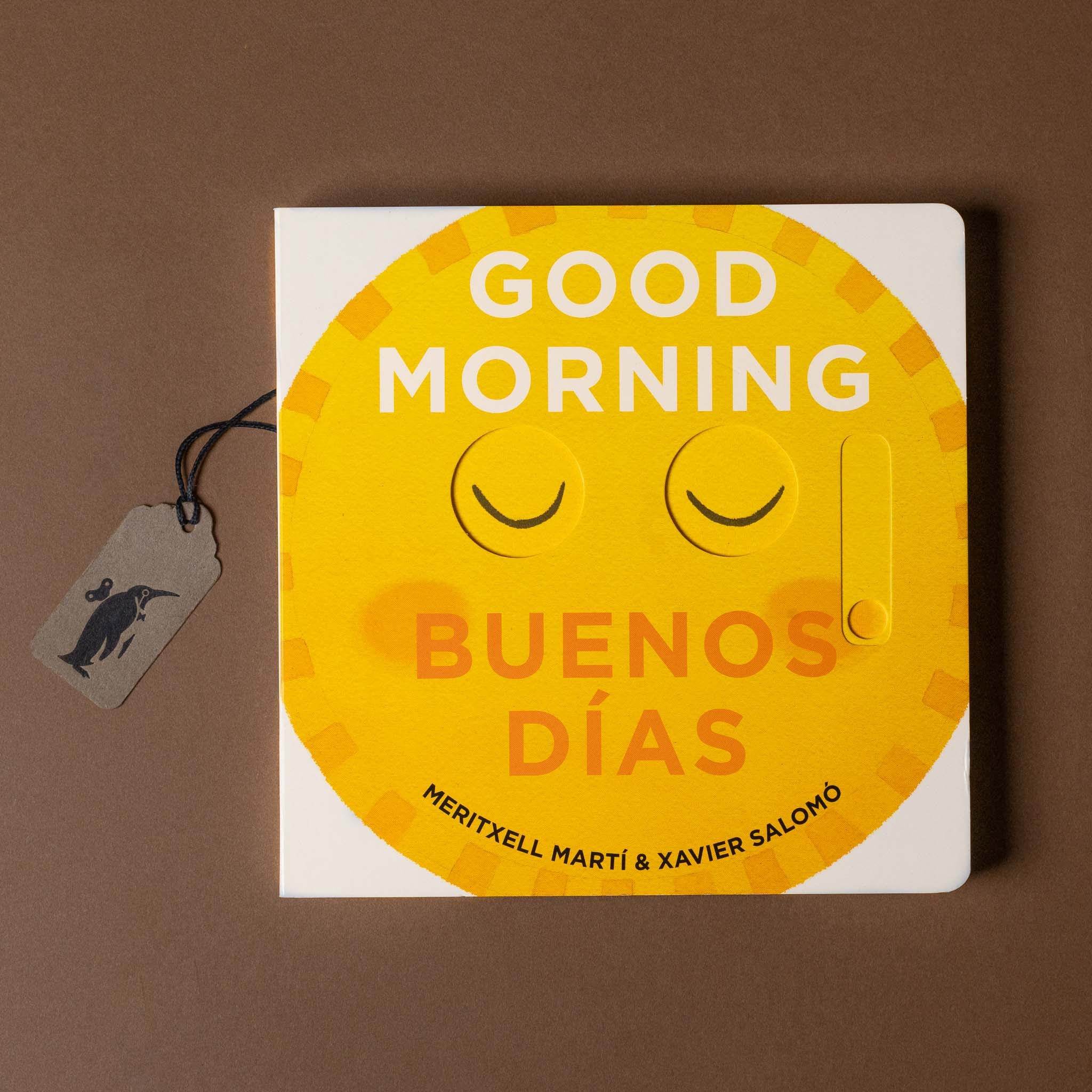 Children's book titled 'Good Morning Buenos Dás' with a yellow cover and white text on a brown background.
