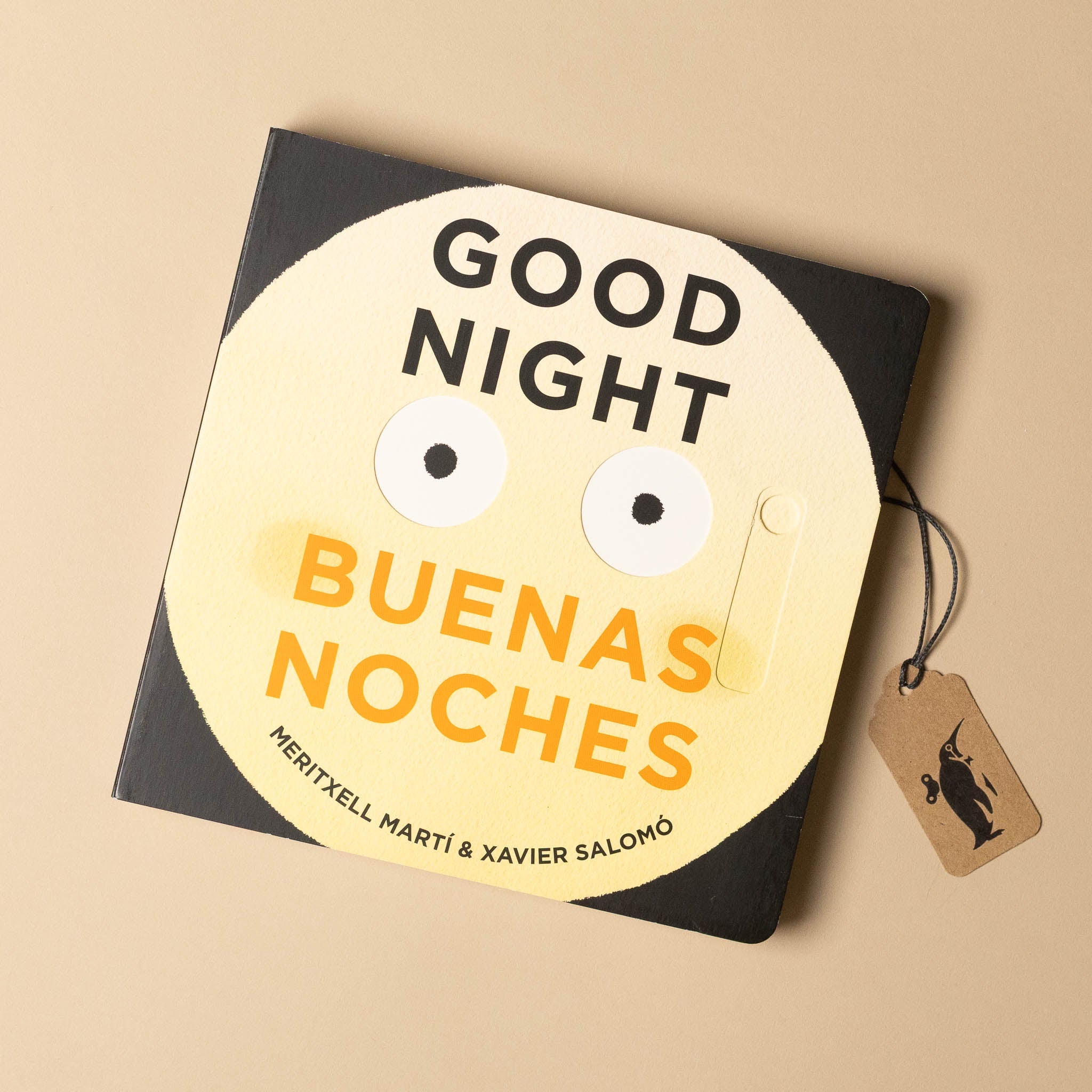 Book titled 'Good Night Buenas Noches' with a face design on a beige background