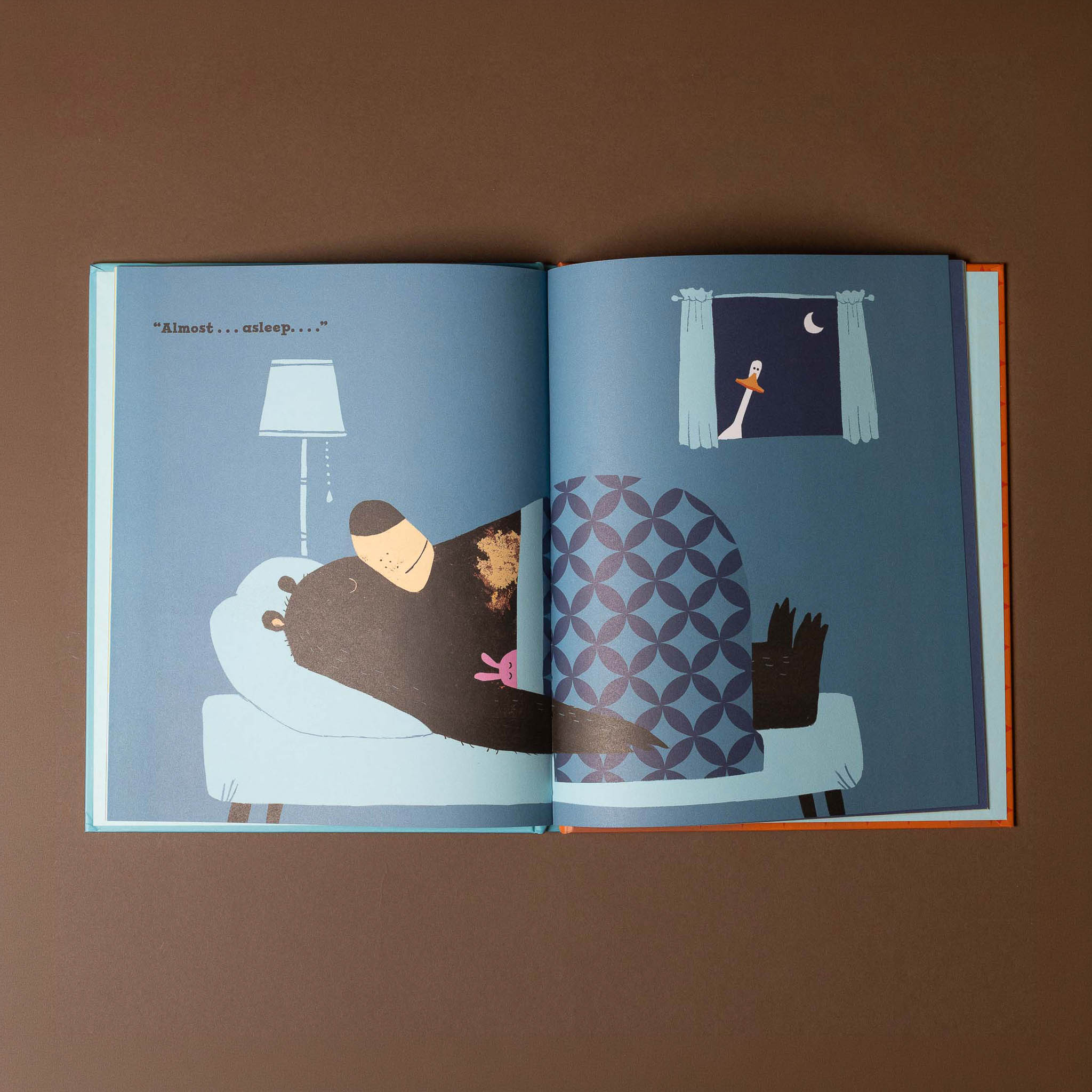 Open book with illustrations of a couple in bed and a bird outside a window.