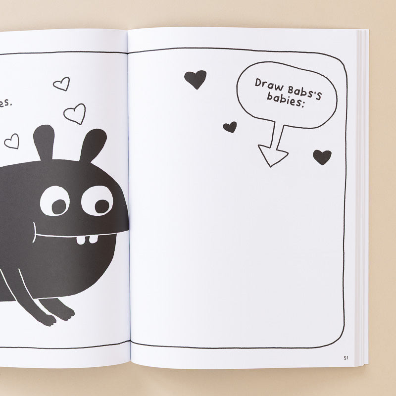 An open children's book or art activity book on a beige background, showing a black cartoon monster on the left page and a speech bubble on the right page that reads 'Draw Babs's babies:' with small heart shapes.