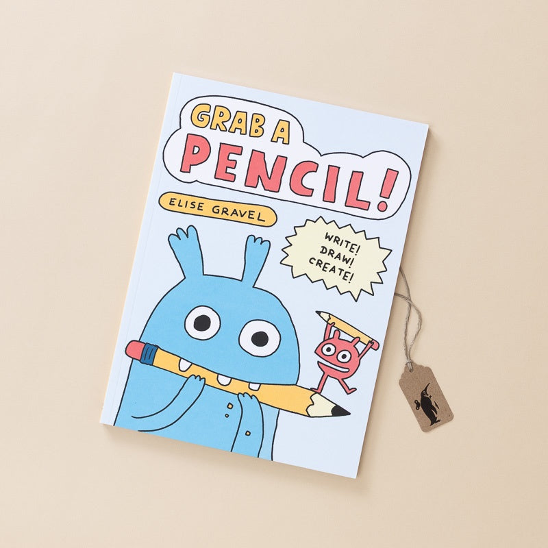 A children's book titled 'Grab a Pencil!' by Elise Gravel, featuring a light blue monster holding a yellow pencil on the cover, shown on a warm beige background with a small wooden tag attached.