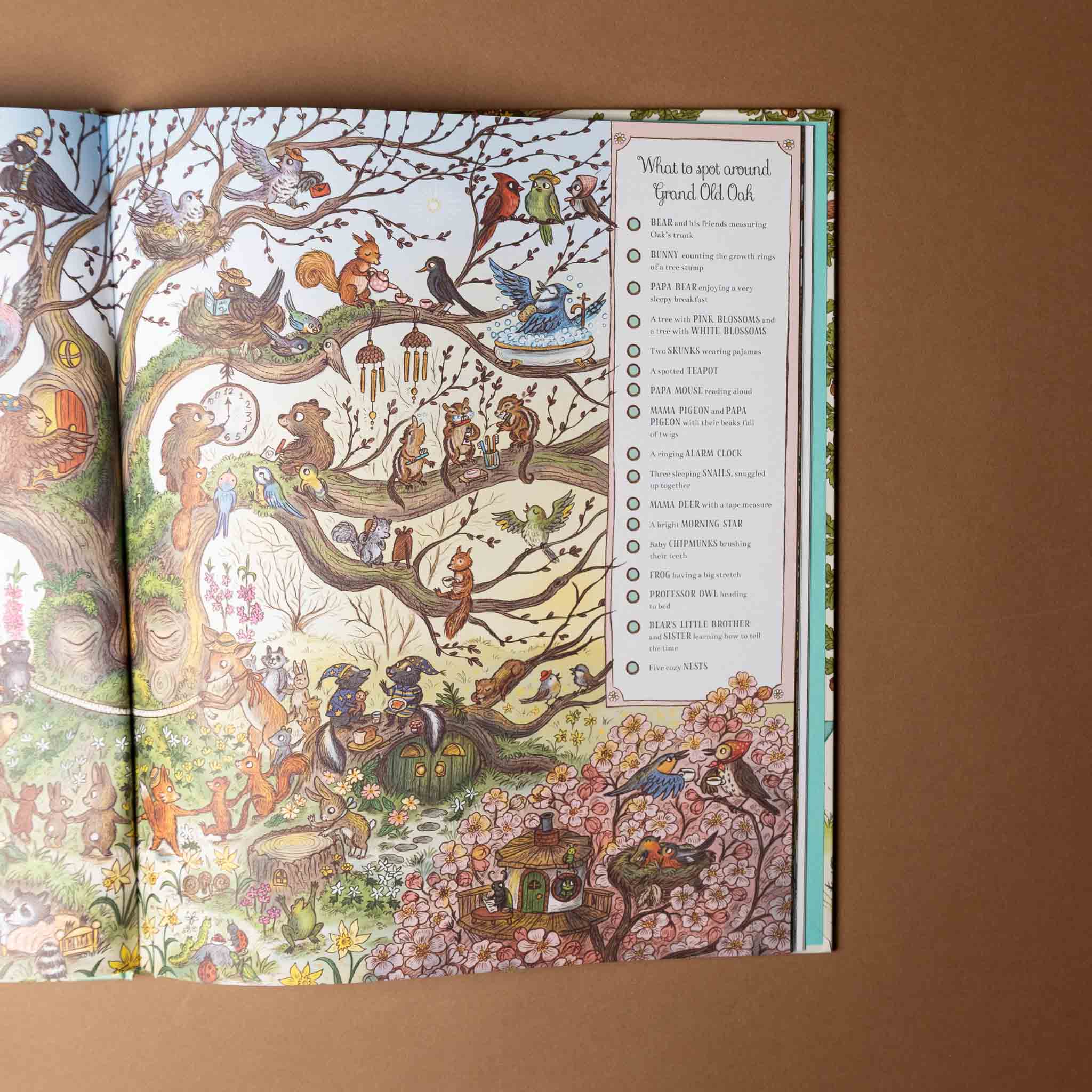 grand-old-oak-and-the-birthday-ball Open book with detailed illustrations of animals in a forest setting on a brown background