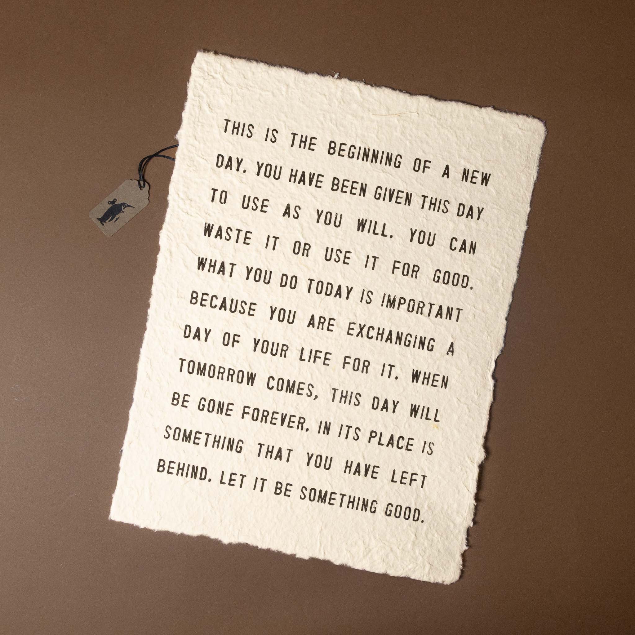 Motivational quote on a textured paper with a tag on a brown background