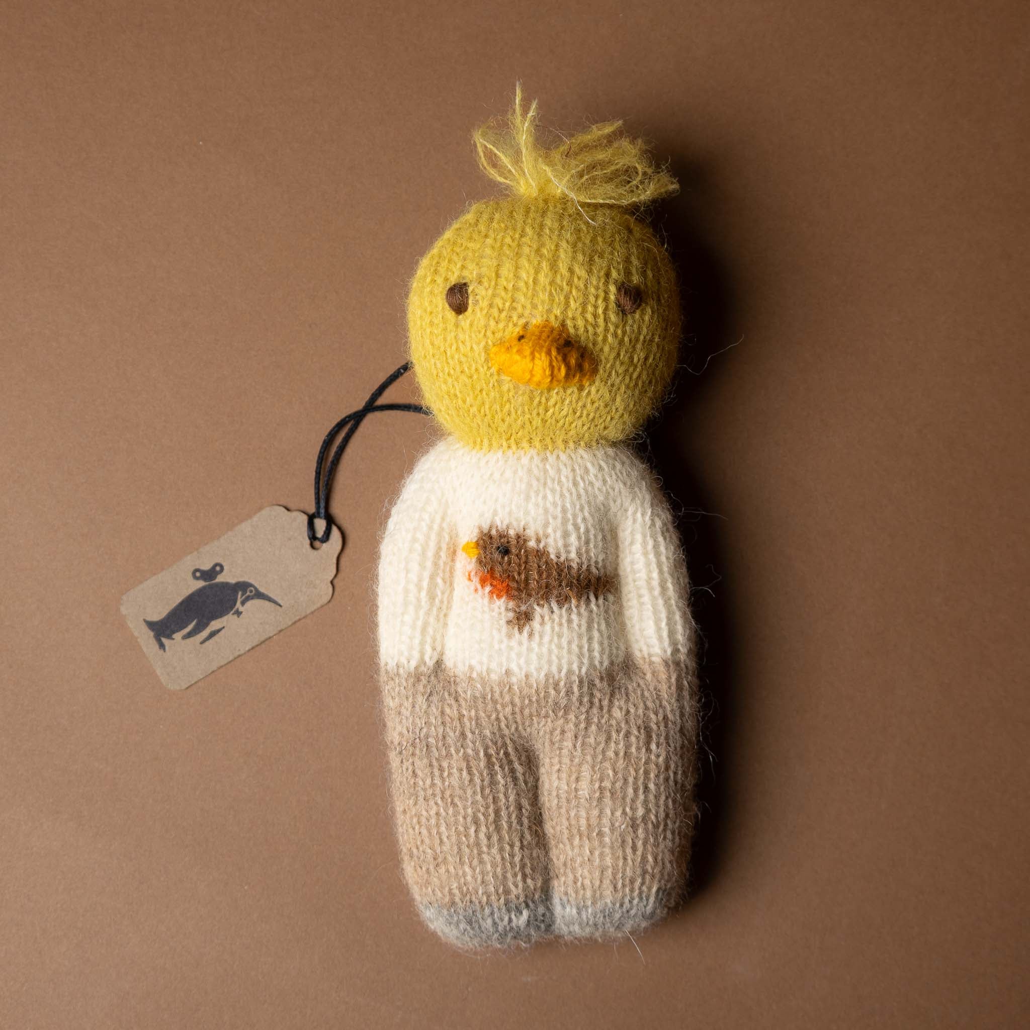 happy-go-lucky-duckie Knitted duck toy with a sweater on a brown background
