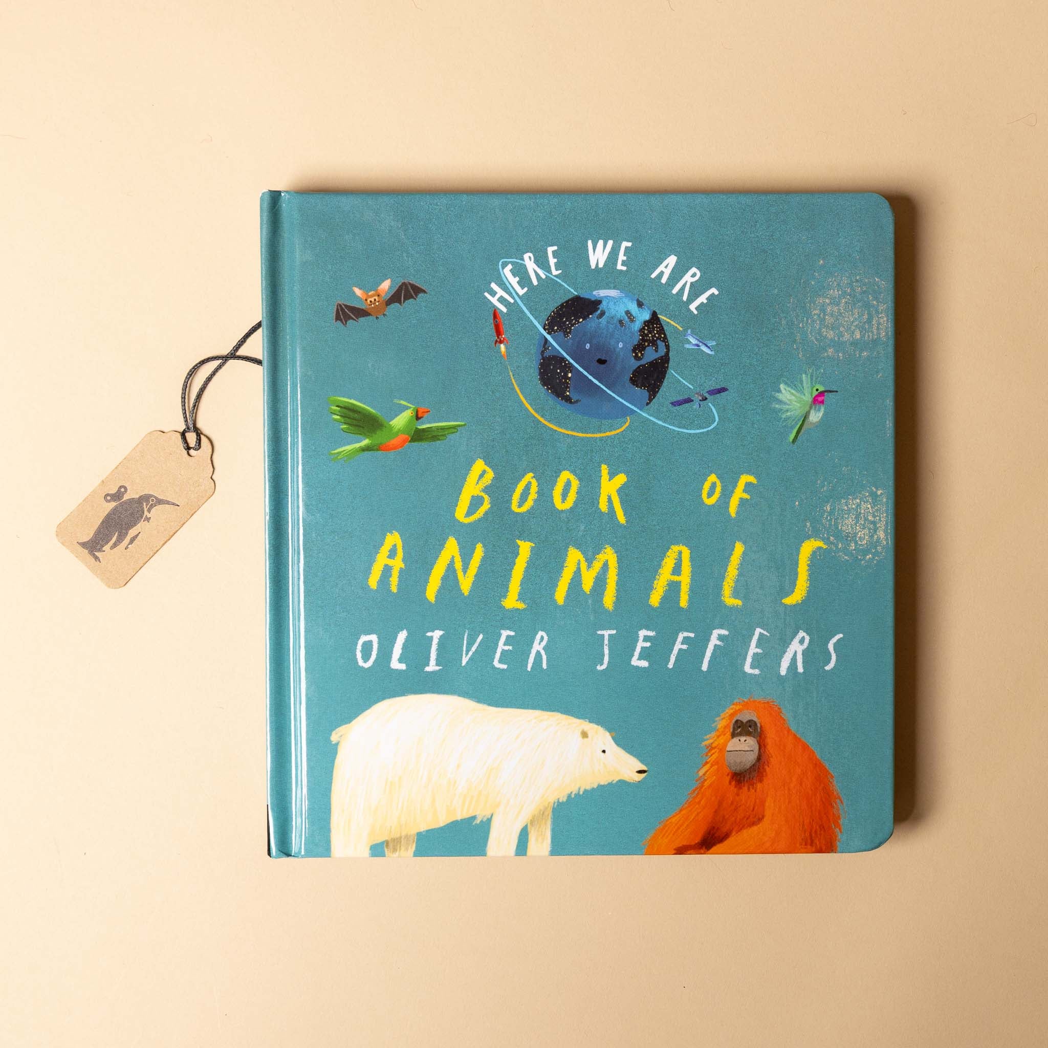 Book titled 'Here We Are Book of Animals' by Oliver Jeffers on a beige background