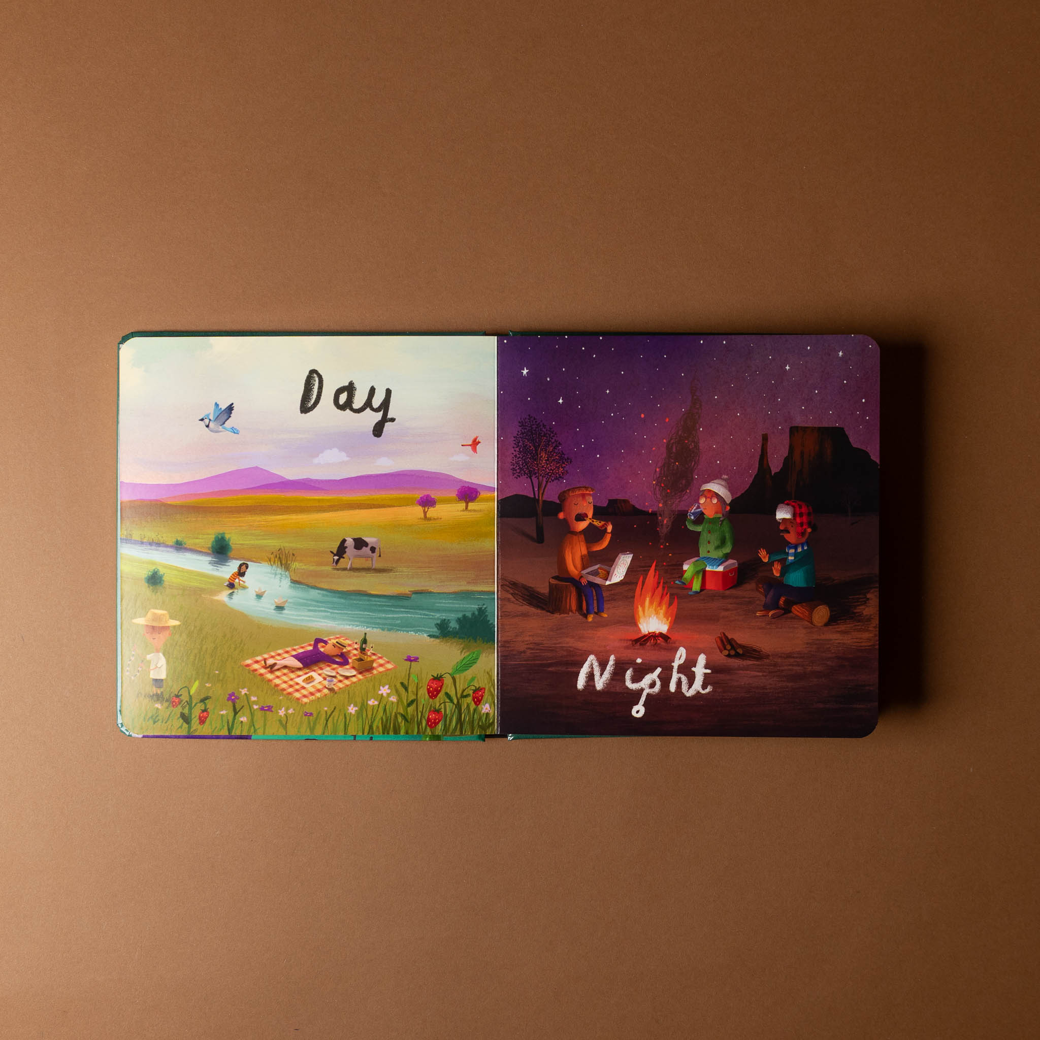 here-we-are-board-book-of-opposites Illustrated book open to 'Day' and 'Night' on a brown background