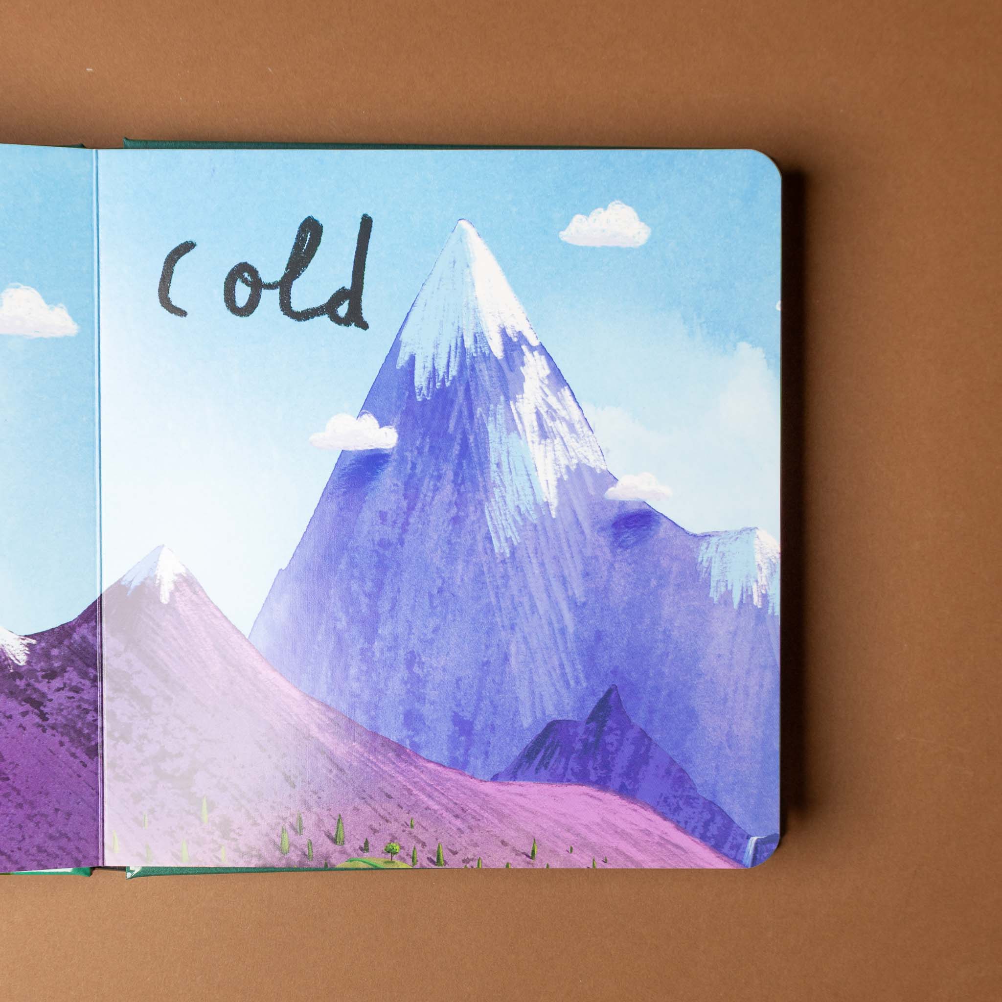 here-we-are-board-book-of-opposites Illustrated book with a mountain scene and the word 'cold' on a brown background
