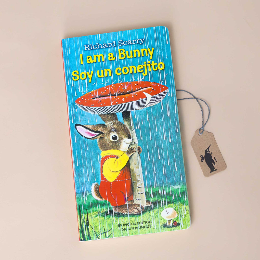 i-am-a-bunny-soy-un-conejito-board-book-cover-with-a-bunny-in-red-overalls-and-yellow-shirt-using-a-mushroom-as-an-umbrella