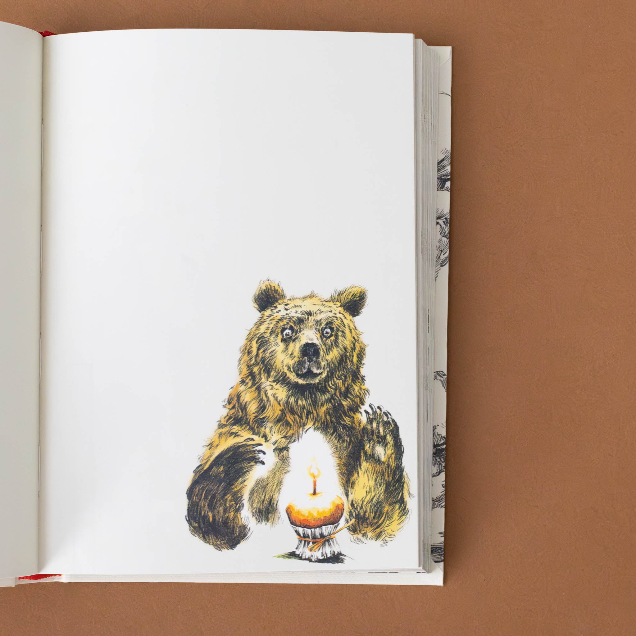 illustration-of-a-bear-with-wide-expression-eying-a-candle-in-a-birthday-cake-in-corner-of-blank-journal-page