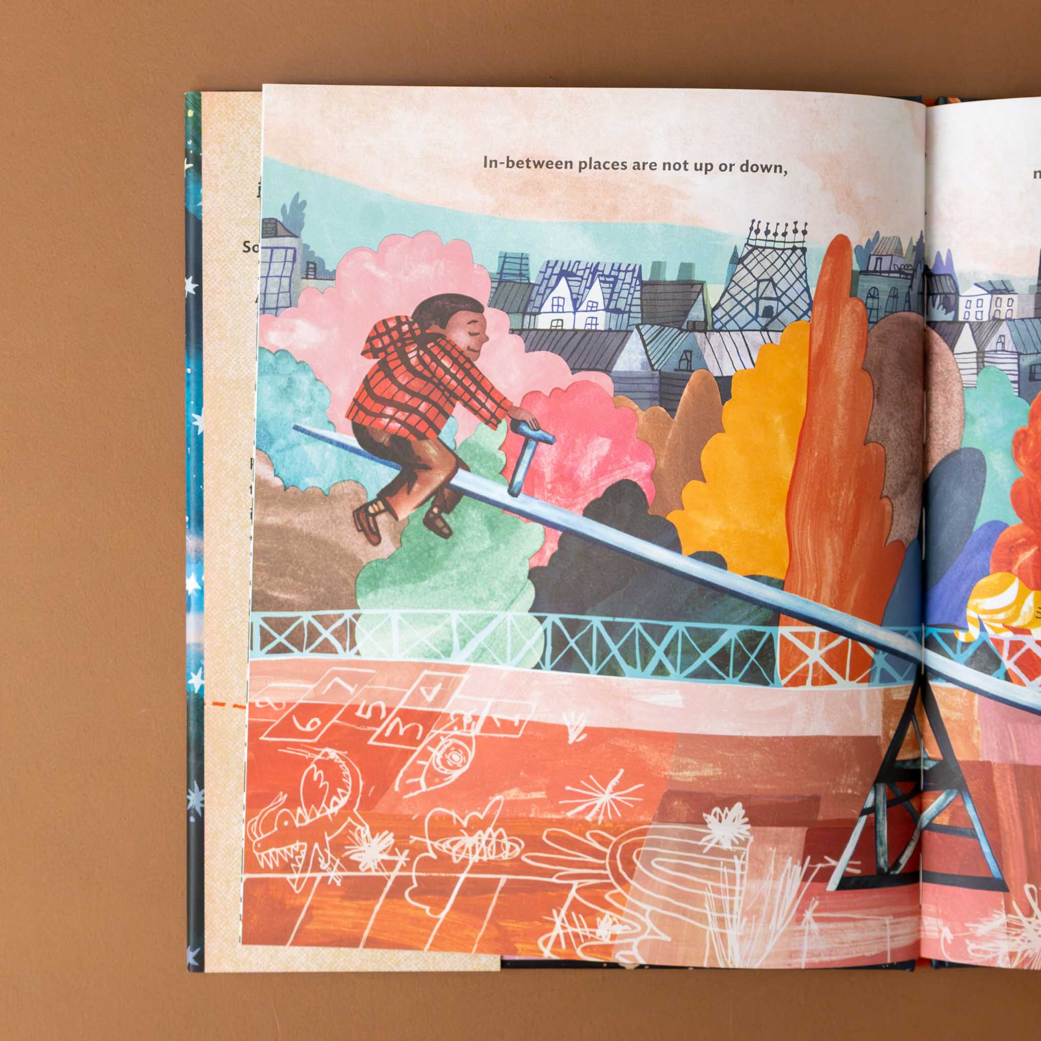 in-between-places-book-page-child-on-teeter-totter-with-text-in-between-places-are-not-up-or-down