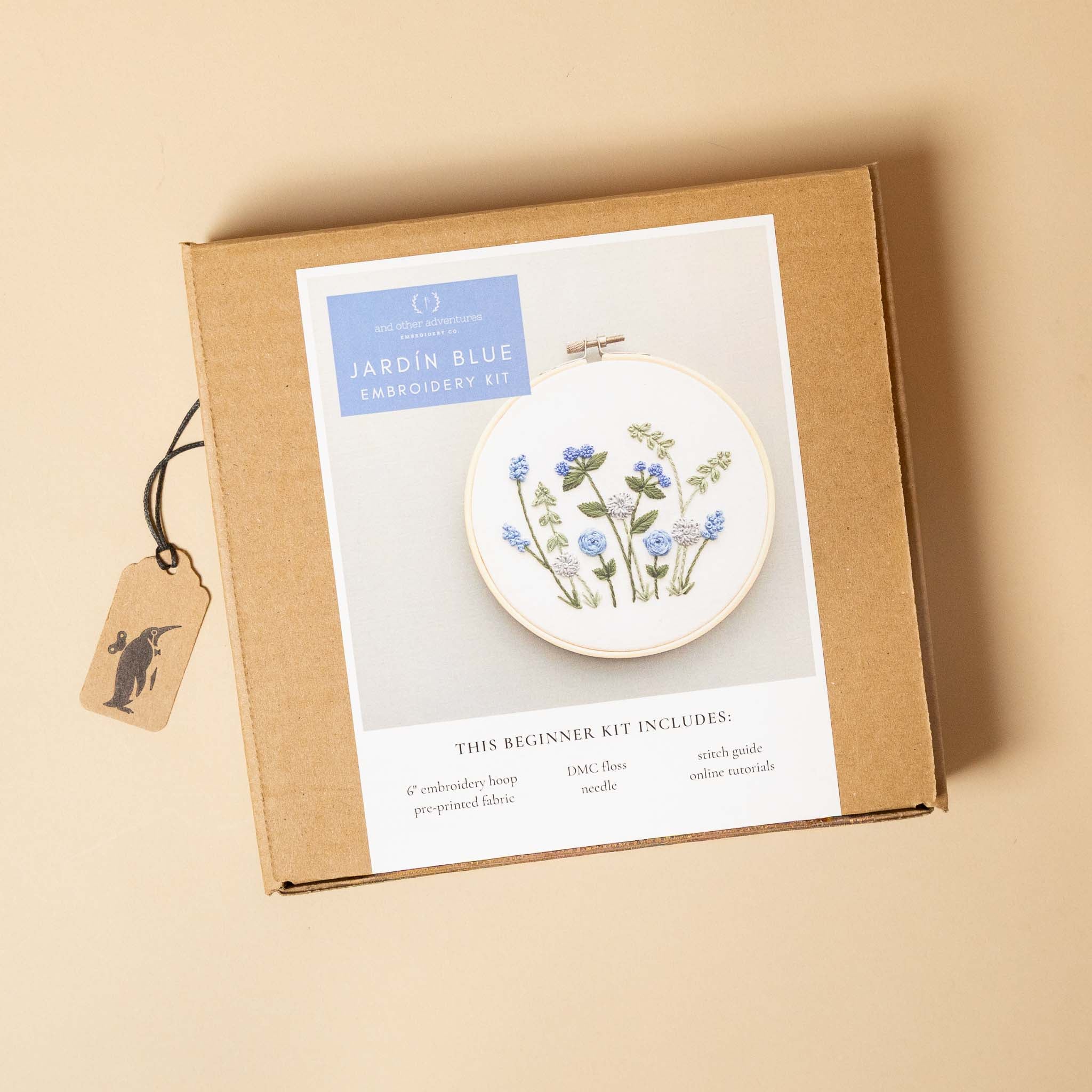 jardin-embroidery-kit-blues with hoop and floral design on a beige background