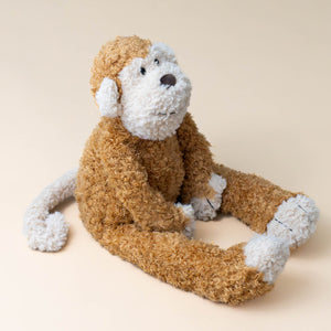 stuffed-animal-junglie-monkey-cream-face-and-paws-with-carmel-colored-body-sitting-with-legs-outstretched