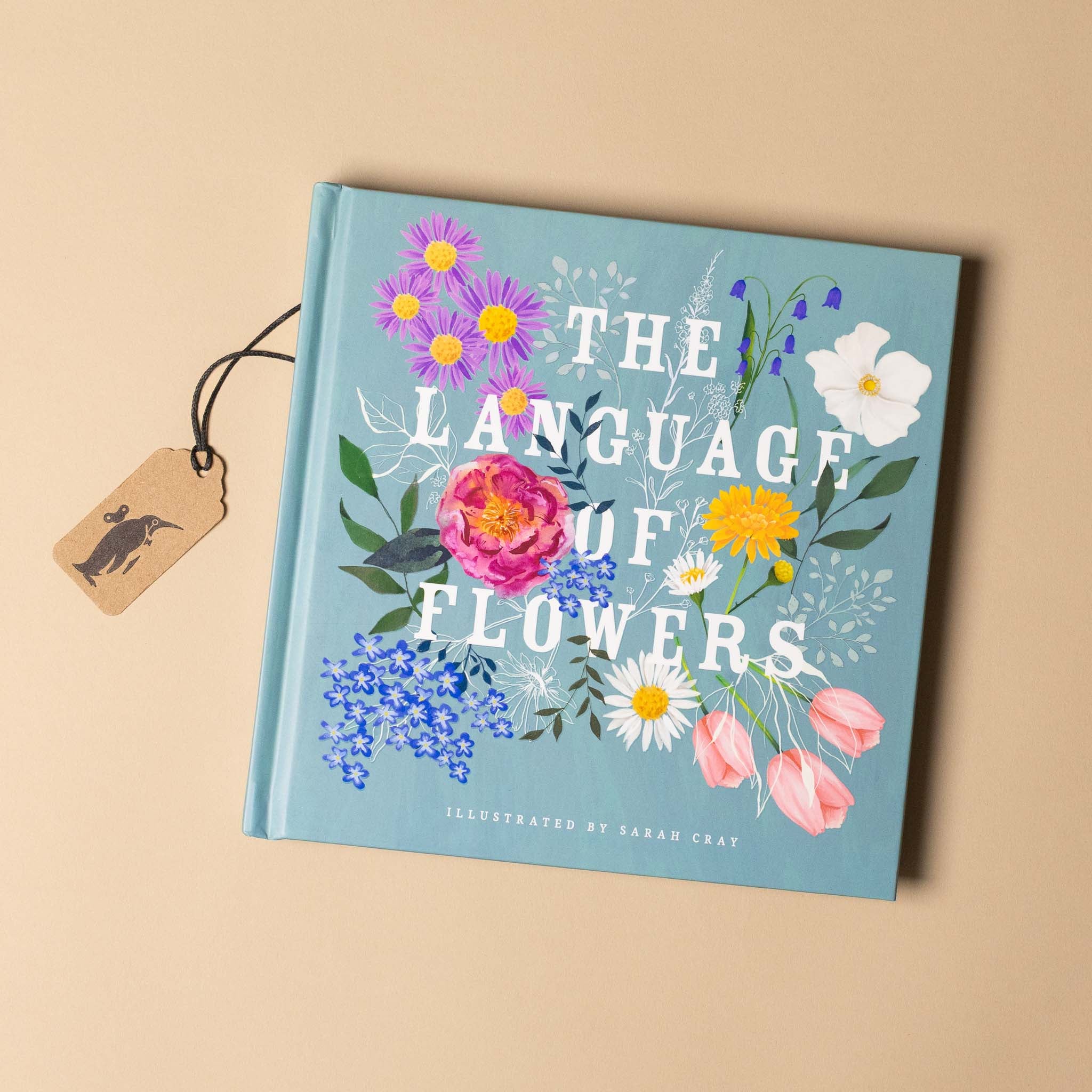 Book titled 'The Language of Flowers' with floral illustrations on a beige background