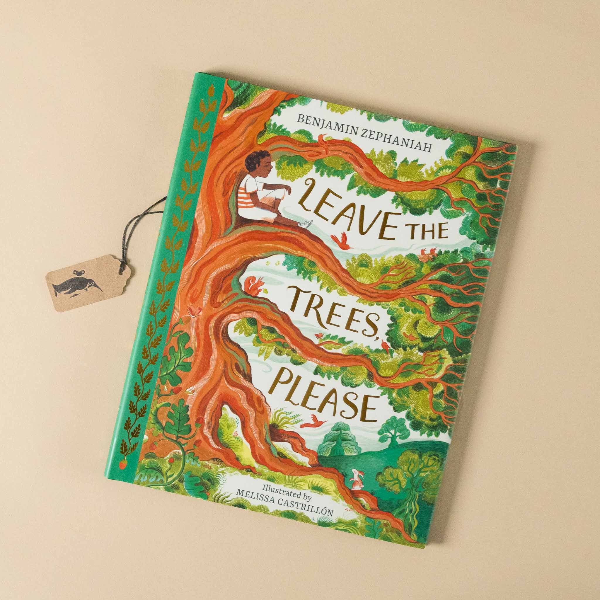 Children's book titled 'Leave the Trees Please' with colorful cover on a beige background