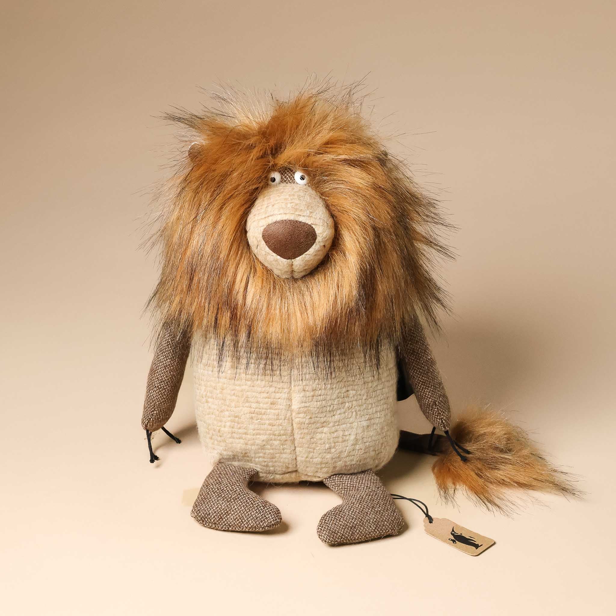 legend-leo-lion Stuffed lion toy with a tag on a beige background